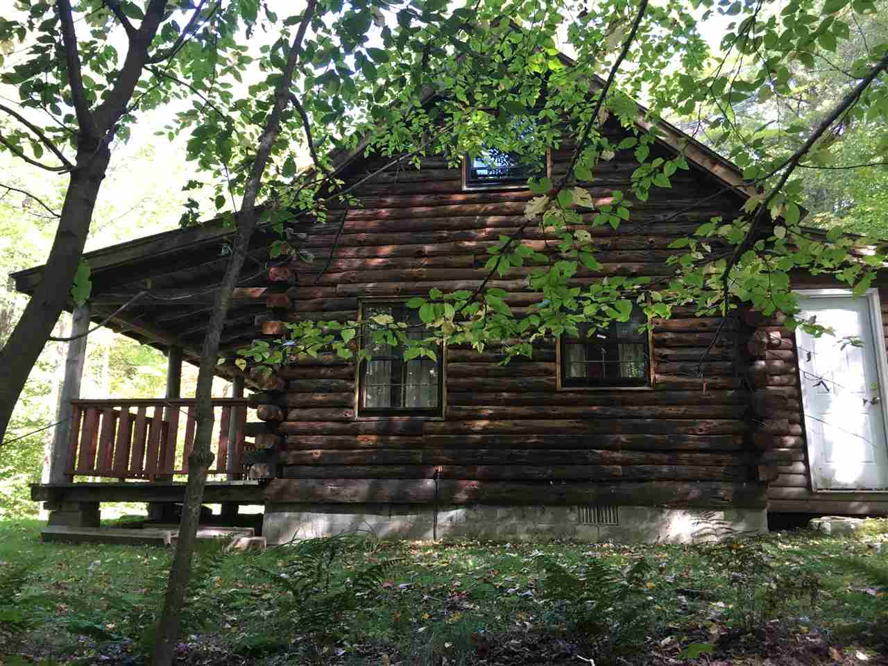This authentic log cabin features a woodstove and...