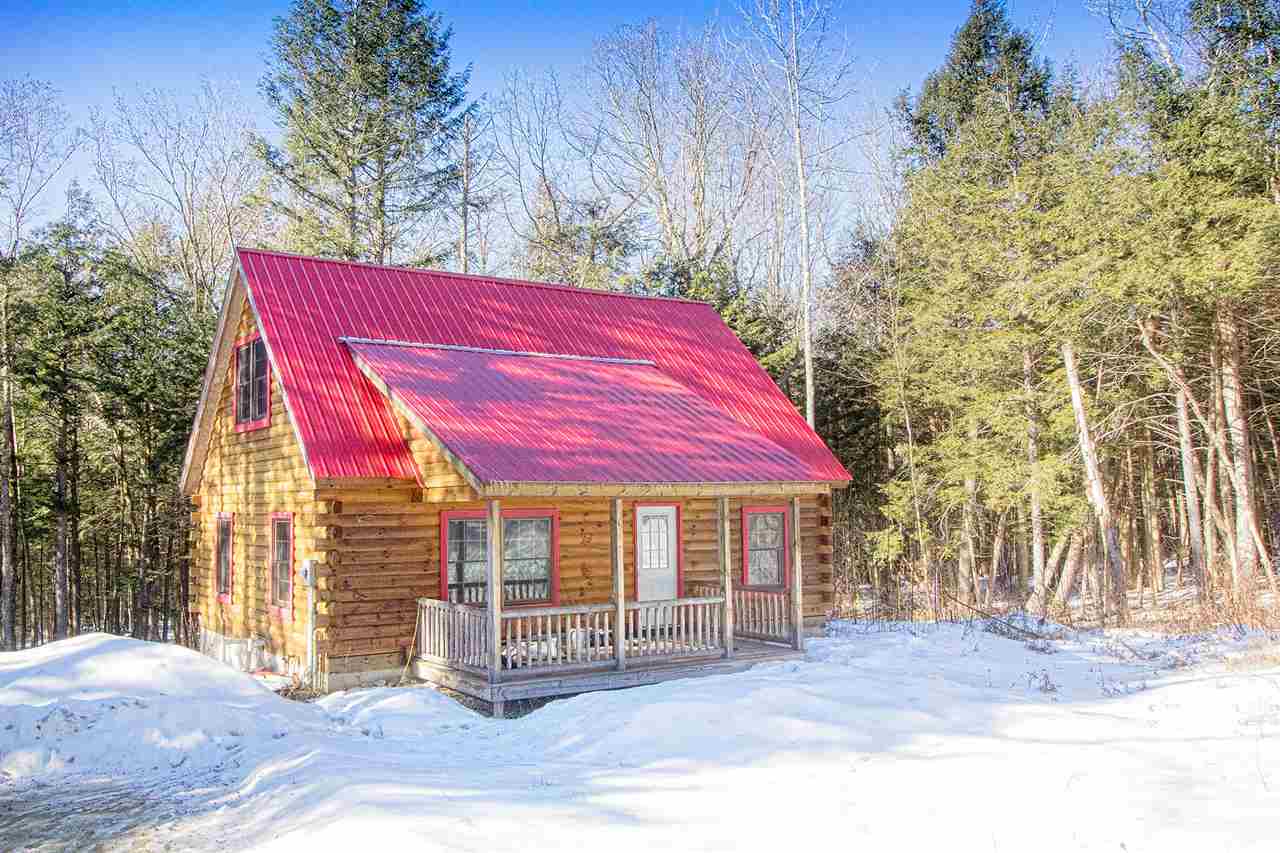 Authentic log cabin tucked away in the woods of...