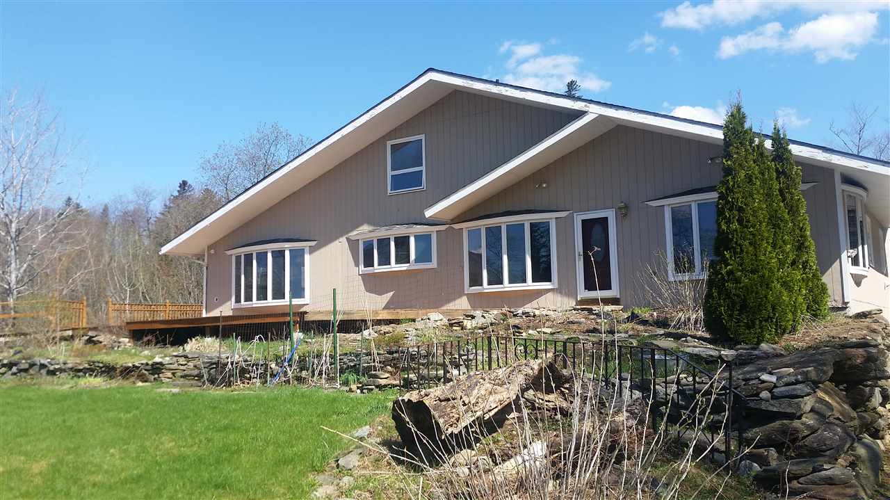 Set on a private 4+ acre lot with pond and views...