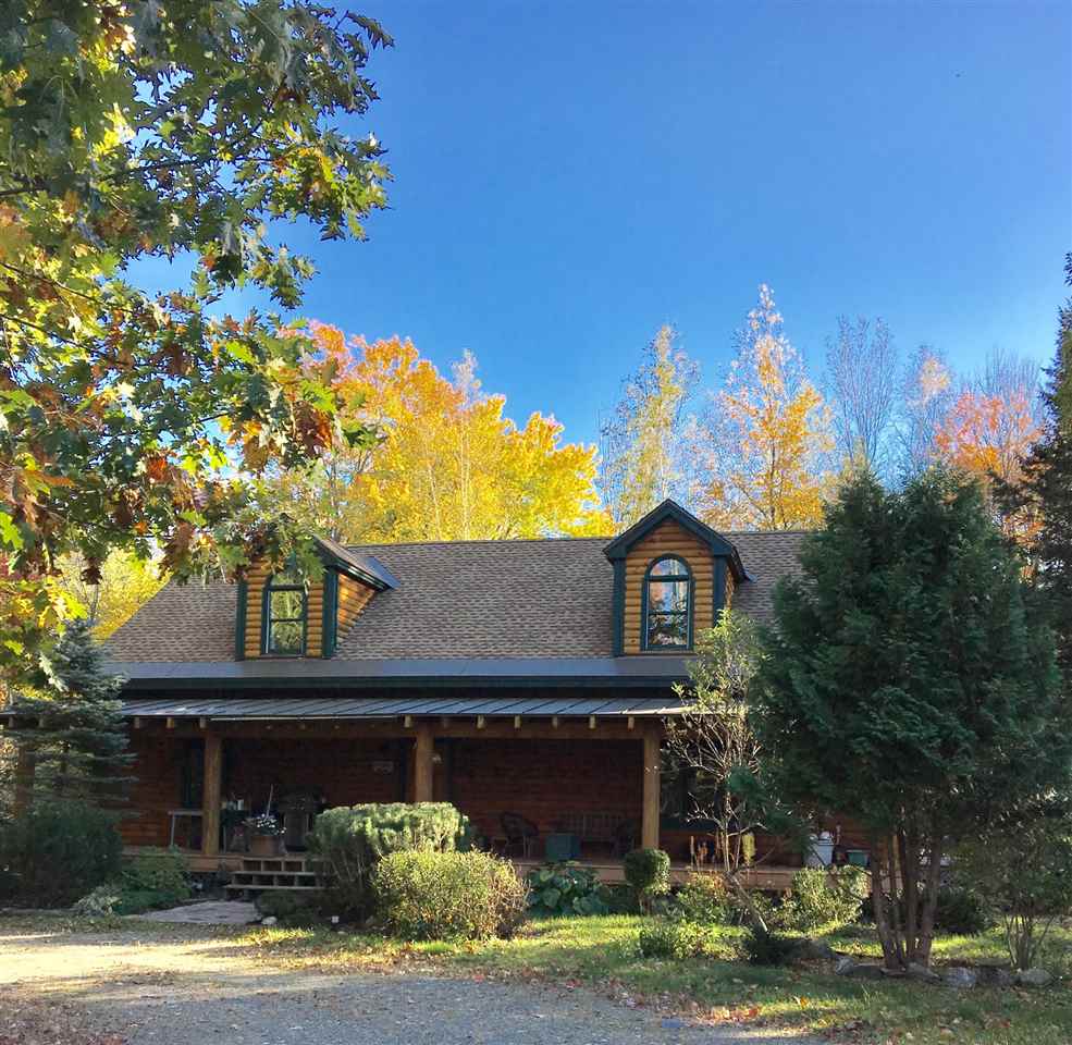 Beautiful log home on 14.2 acres of fields and...