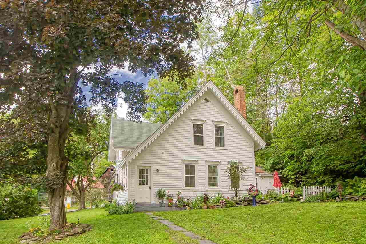 Enter this charming village home boasting an open...