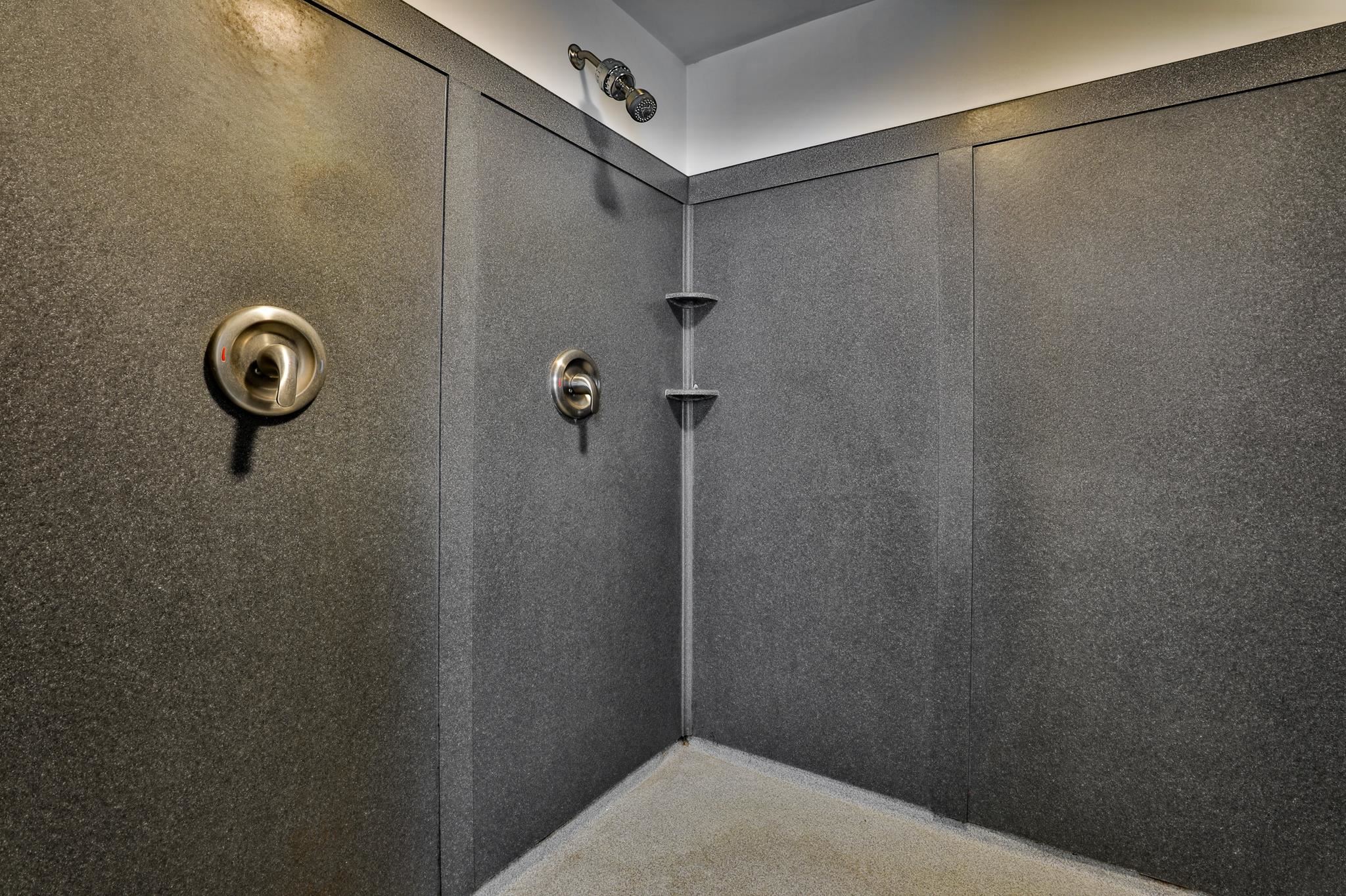 Two shower heads with a headed floor makes showering relaxing.