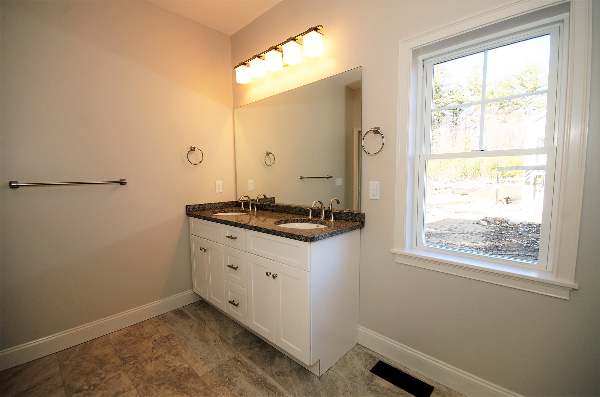 Upgraded tile floor, standard Granite counter top with double sink vanity.