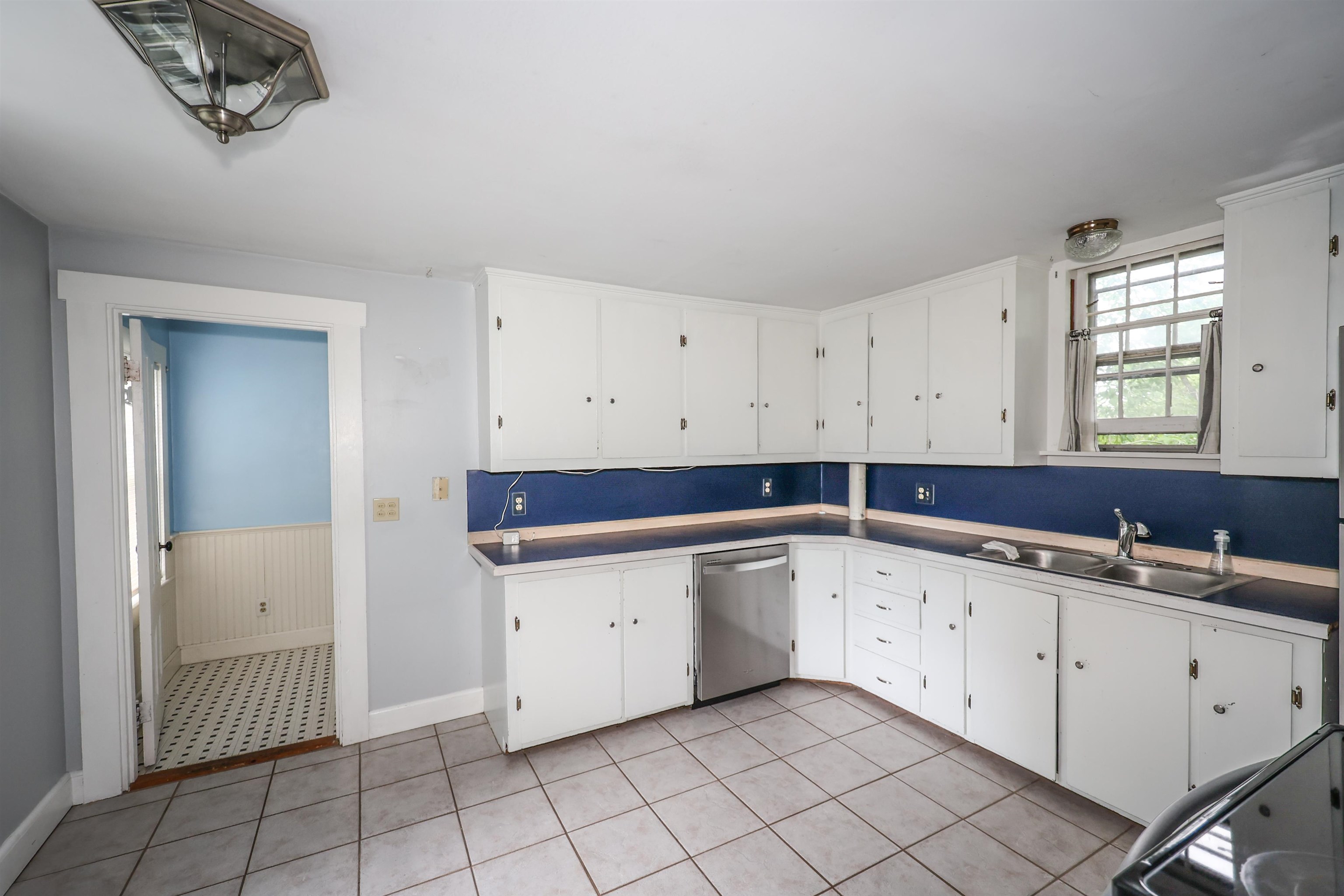 Unit A - Nice sized kitchen with tile flooring and stainless steel appliances
