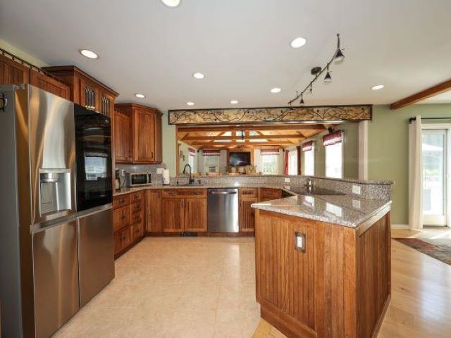 Open flow to the living room, large breakfast bar, plenty of cabinets and high end appliances!