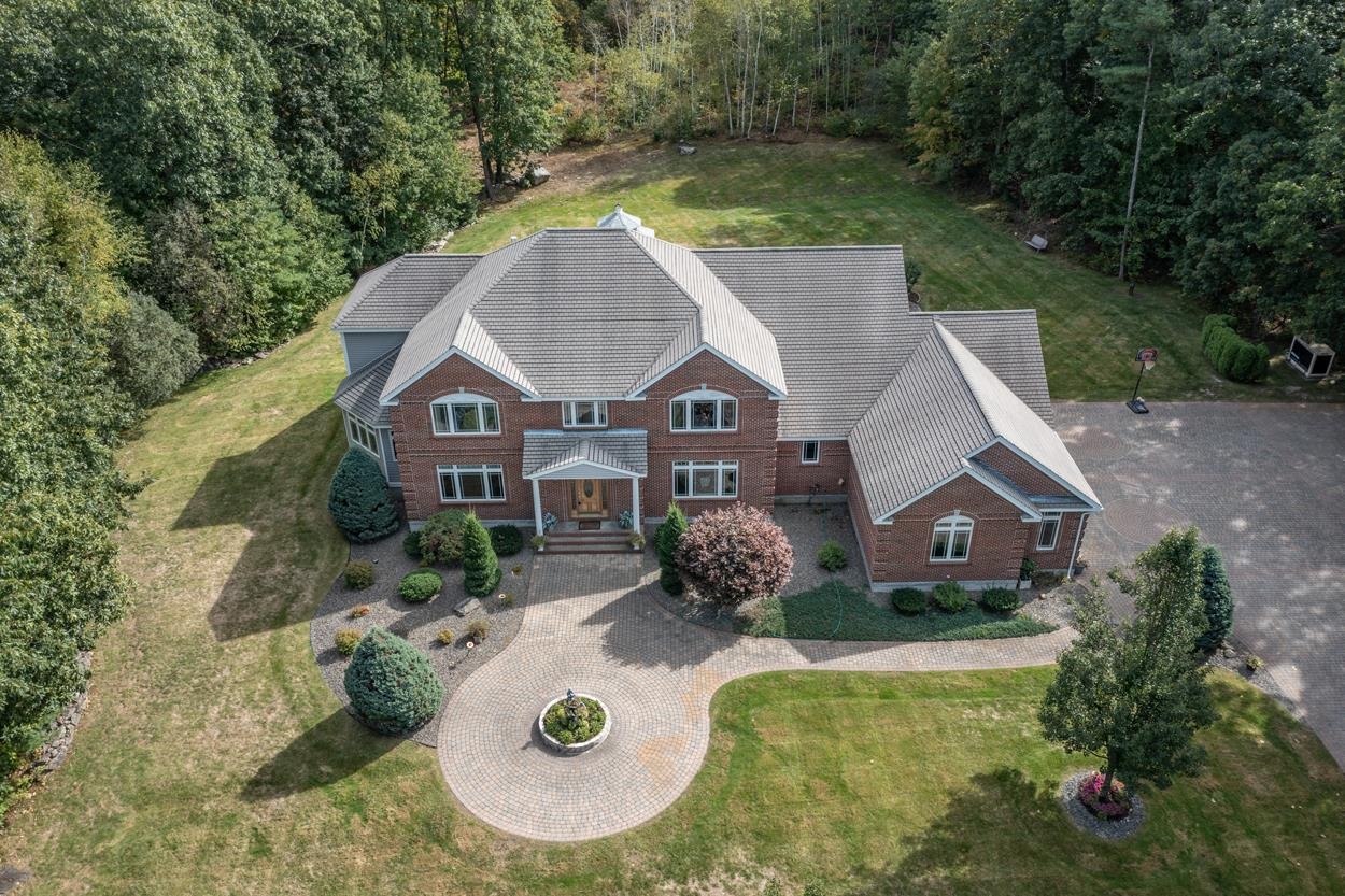 This home has it all, privacy, style, convenience and efficiency. Tucked back from the road this estate quality abode boasts craftsmanship built to last for a lifetime. Energy conscious Buyers will appreciate the 25KW Seller owned roof mounted solar array and 3 new Geo Thermal heat pumps . An elegant 2 story foyer welcomes you in with a curved staircase leading to a catwalk balcony above. Sun filled Living room has a wall of windows beckoning you to the private  backyard, screened in gazebo and large Fiberon deck. The custom chef's kitchen contains everything you need to entertain with red birch cabinets, Thermador 6 burner cooktop, grille, double ovens,  Sub Zero side by side fridge/freezer. 1st floor primary suite has it's own sitting room, ensuite spa bath plus an adjoining office with built in cabinetry. Or choose Potential 2nd primary bedroom upstairs with it's own full bath with soaking tub, tiled shower, 2 walk in closets plus access to newly sheetrocked bonus room over the garage. Lower level  game room, built in red & white wine fridge, beverage drawers, Finlandia 4 person Ever Ready Sauna and Steam shower plus multiple finished rooms for entertaining family and guests. 4 car heated garage and single detached garage. Exceptional location convenient to shopping, schools, and highway and everything the town of Windham has to offer.  Full List of amenities available. New 6 bedroom leach field to be installed spring 2023.  Some Seller financing possible.
