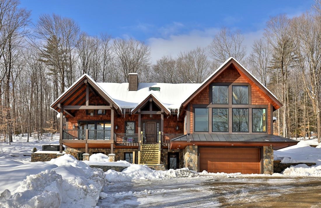 This beautiful and very spacious newly constructed home, with energy efficient upgrades, has over 6,000 square feet of living space on three levels. Within walking distance to the slopes, located close to the Base Lodge area, this home has everything a ski home needs. Enter through the carefully crafted front door into one of the two mudrooms, or through the two car garage or by the side mudroom and you will see walls of three-pane glass picture windows (for insulation and acoustics) looking at your mountain range view. An open floorplan with vaulted ceilings, large chef's kitchen with an island, hickory flooring, dining and living room with a fireplace that has a metal insert with internal blowing. There are 5 and a half bathrooms, plenty of spacious bedrooms, and a beautiful media/recreation room with a wall of windows, vaulted ceiling and view, which will be a fun space for entertaining guests! A hot tub, and covered porch/deck add to the exterior ambiance. Radiant heat on the ground floor, air recuperation system, 2x8 walls, foam insulation in walls and roof and more!