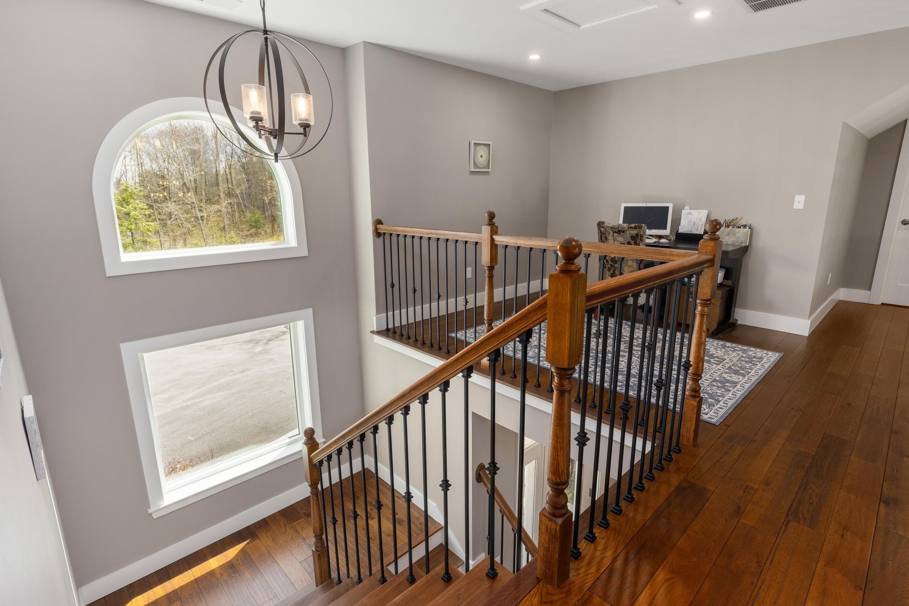 Grand stairway to 2nd level that offers 3 additional bedrooms, 2 baths, 2 storage closets