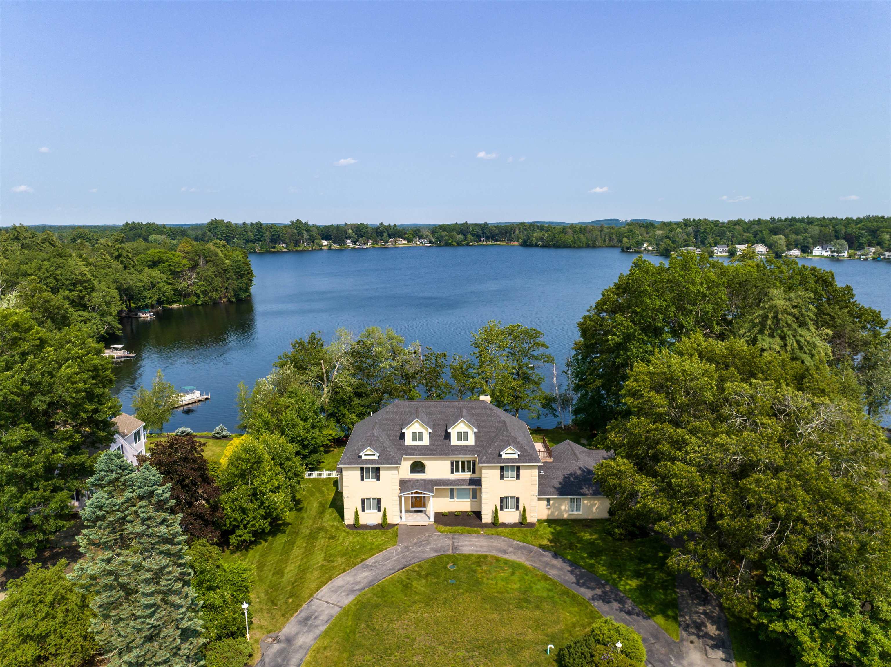 EXPANSIVE WATERFRONT Welcome to the epitome of waterfront luxury on Canobie Lake! This exquisite 5,000+ sq ft residence is a haven of elegance and tranquility, boasting an impressive 215' of pristine water frontage. As you step into the grand foyer, you'll immediately be captivated by the sheer beauty and opulence that define this property. The main floor offers a seamless flow from room to room, featuring an expansive family room adorned with a charming fireplace, formal dining room and well appointed office. Large windows throughout allow for an abundance of light and breathtaking views. You will be inspired by the amazing kitchen equipped with a large center island, state of the art appliances and butler's pantry - every chef's dream kitchen! This home offers two primary suits, one on each floor - to cater to your utmost comfort and privacy. Wake up each morning to the soothing sounds of the lake and breathtaking views from your private balcony or terrace. Two additional en-suite bedrooms, each offering its own private balcony, ensure everyone enjoys a retreat-like experience as well as a second floor loft. A finished third floor offers endless possibilities. With an impeccable design, breathtaking views, and lavish amenities, this home is sure to surpass all your expectations. Close to shopping, dining and minutes to Rte 93! Showings begin Saturday 7/22 at open house
