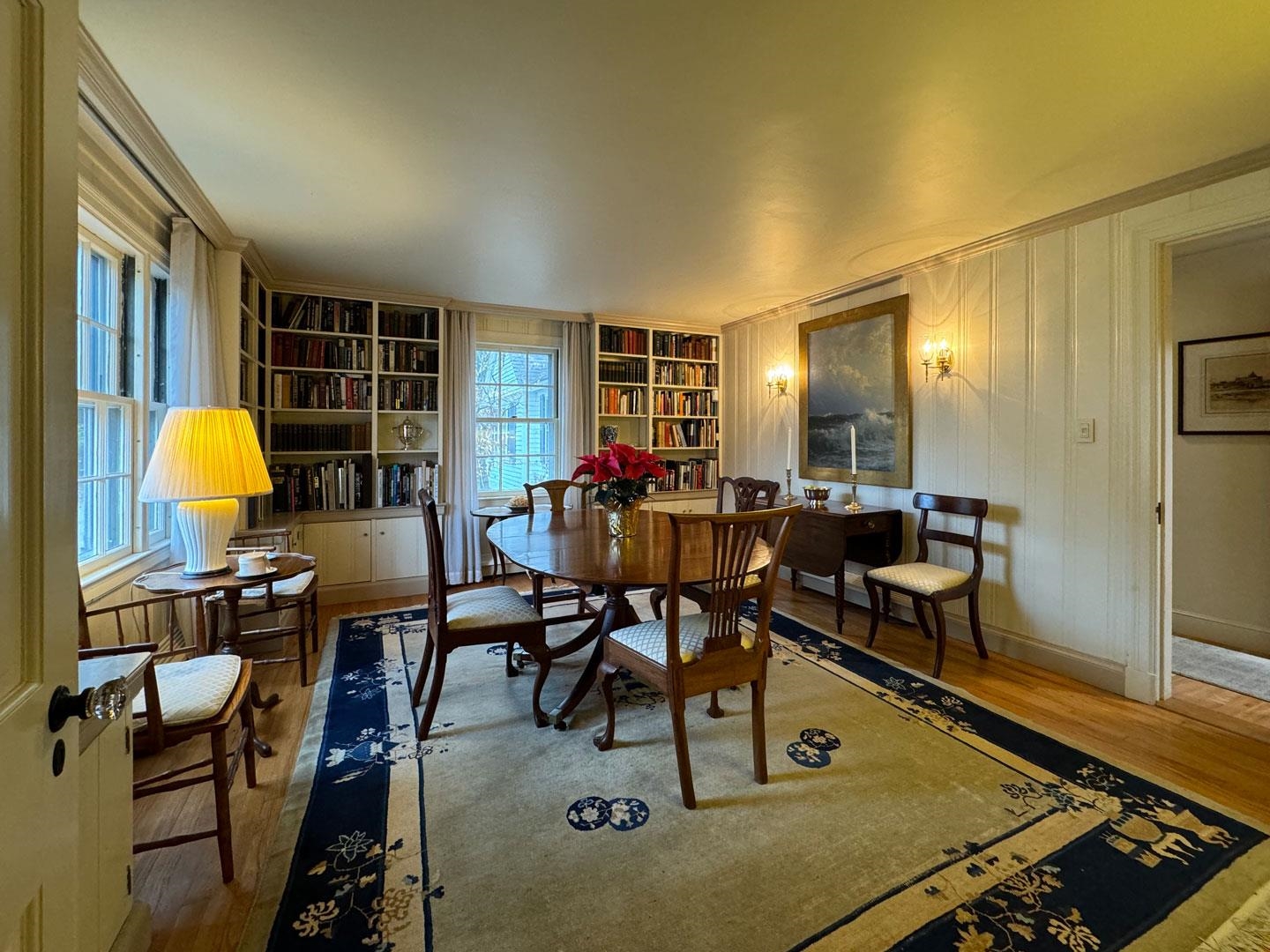 Stunning formal dining room with built-in bookcases and large windows