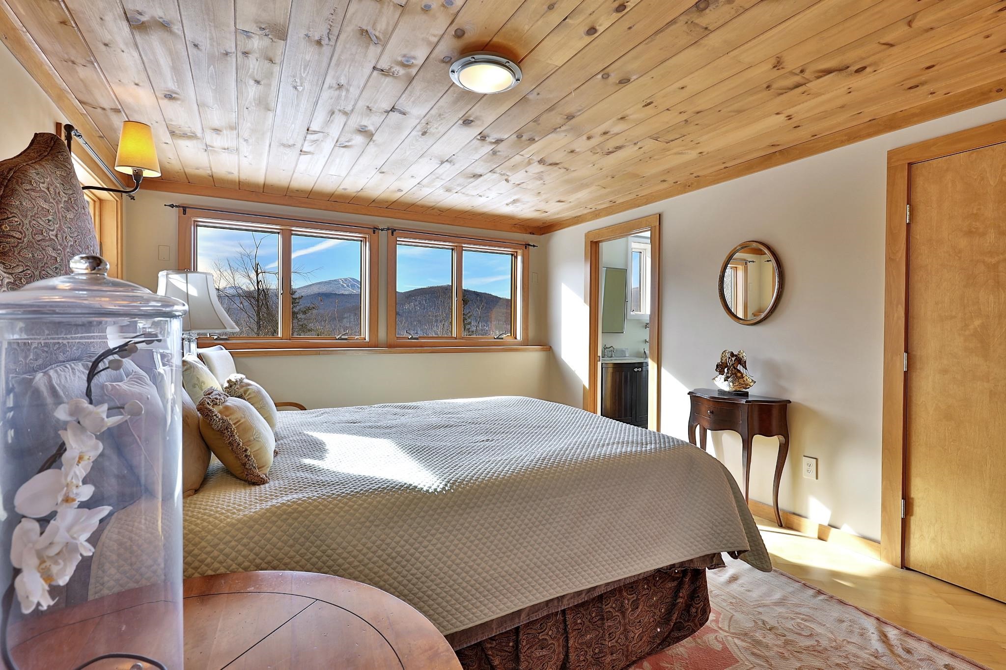 Downstairs primary bedroom with views of Killington and Pico.