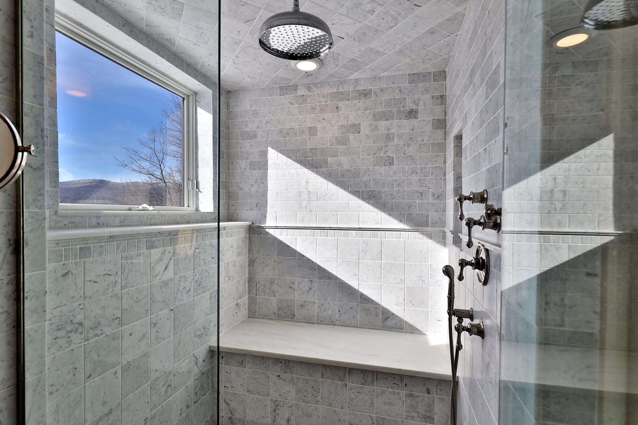 Downstairs primary ensuite bathroom steam shower with views of Killington and Pico.