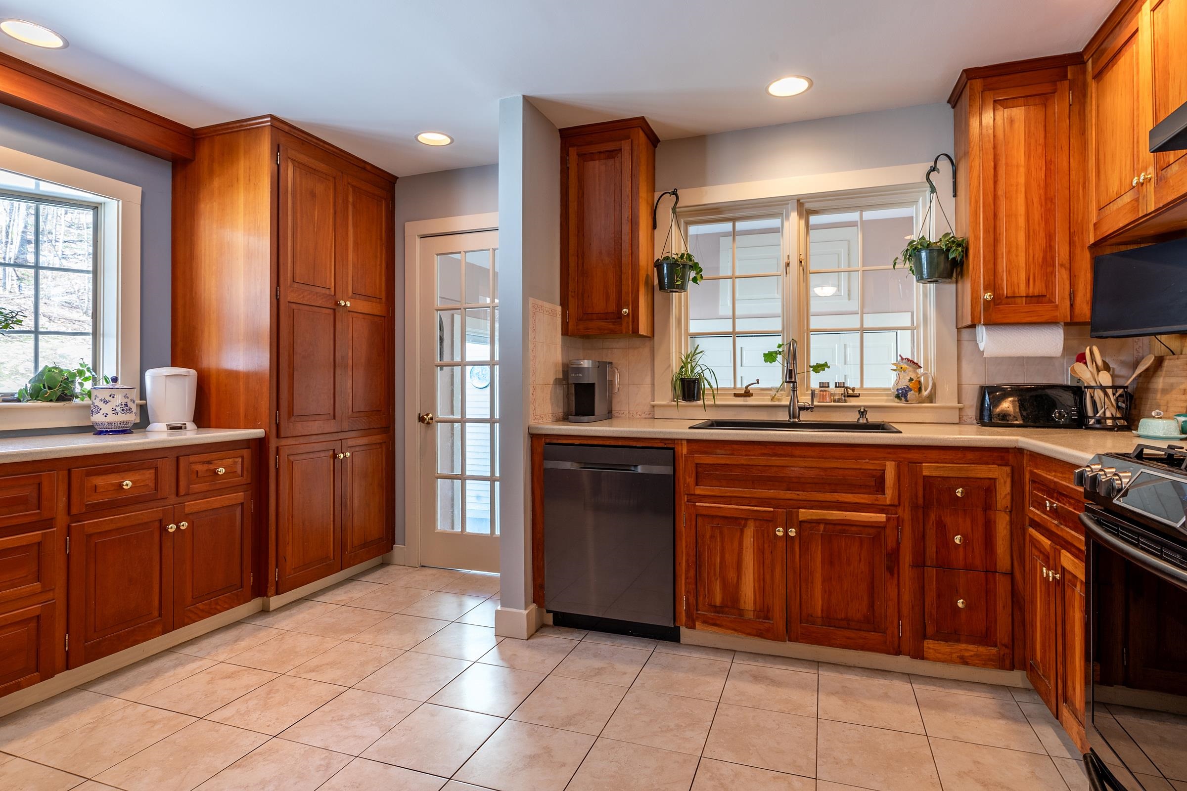 A bright kitchen with cherry cabinets