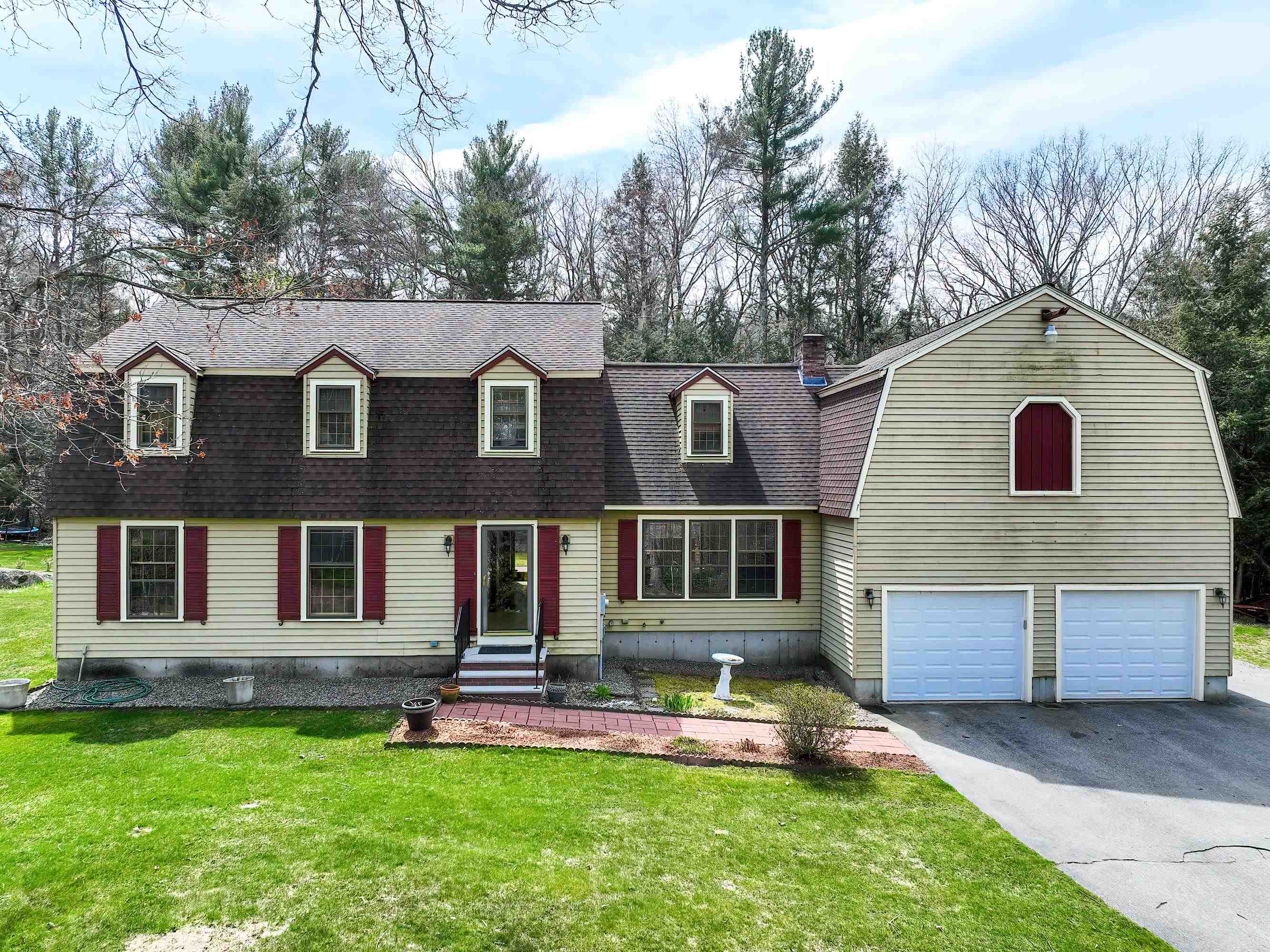 This Beautiful Gambrel in a sought after Windham neighborhood paints a vivid picture of a charming and inviting home! The ample lot size and thoughtful landscaping, including flower beds and blueberry trees, create an idyllic setting. Inside, the gleaming hardwood floors convey a sense of warmth and elegance. The open layout between the dining room, kitchen and family room promotes seamless flow and encourages gatherings. The eat-in kitchen adjacent to the family room enhances the functionality and sociability of the space.  Off the family room you will find the three-season porch a delightful retreat, offering serene views of the private backyard. The practical features, such as the huge mudroom with laundry facilities and the oversized two-car garage, add convenience and efficiency to daily living. The second floor is a haven of comfort with its four spacious bedrooms, including the luxurious primary bedroom suite featuring dual vanities and a walk-in closet. In addition, the unfinished space over the garage presents an exciting opportunity for customization and expansion, allowing homeowners to increase the home's sqft and potentially enhance its value instantly. Finally, the partially finished basement offers versatile options for use, as a home office, a cozy teen retreat, or a dedicated workout area. With so much to offer potential buyers will likely appreciate the opportunity to explore and discover the numerous upgrades and amenities firsthand!