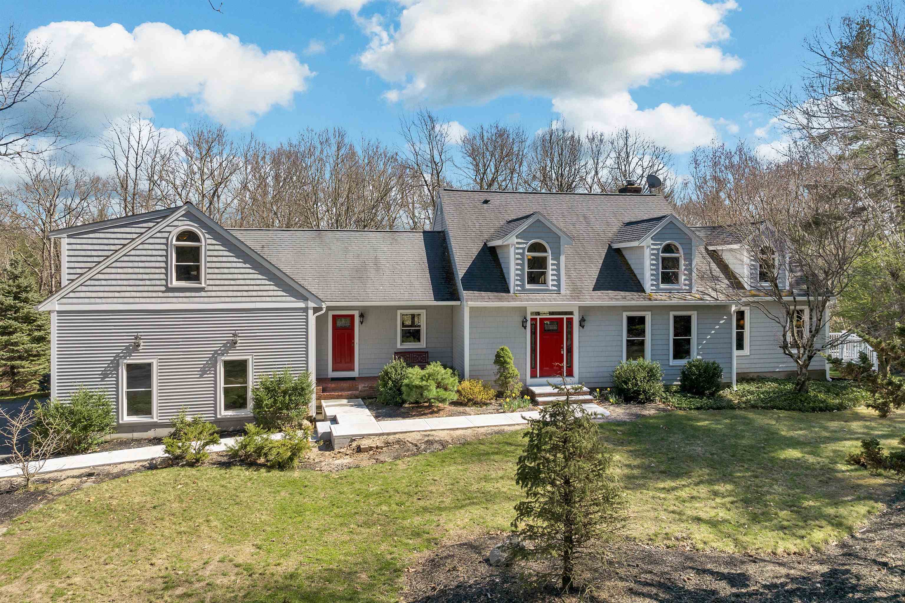 This distinctive, custom cape is privately tucked off the road on a 9.28 acre lot with a first floor Primary bedroom suite. Handsome leaded glass entryway leads to a dramatic open foyer with gleaming hardwoods. The bright and airy great-room offers vaulted ceilings and custom floor to ceiling window overlooking the wooded setting. You’re sure to enjoy the pellet stove surrounded by a brick fireplace. The formal dining room is complemented by vaulted ceilings, hardwood floors and lots of windows. The impressive custom kitchen has a huge center island with seating areas, built-in China cabinets, an abundance of cabinet space and stainless-steel appliances. There is also a media room tucked off the great-room behind French doors. With crown moldings and hardwoods it could serve as a formal dining room as well. The first-floor Primary bedroom suite features a walk-in closet, beautiful bath with spa tub and atrium style door opening to a private balcony. The second floor offers two spacious bedrooms and a full bath. Off the back hall you’ll find the laundry, pantry and powder room and the stairs to a beautiful bonus room over the three-car garage. There is a spacious multi-level deck and big back yard. Plus you’ll love the energy saving features such as the solar panels. The full basement has daylight windows and walks-out to both the back yard and into the garage. What a great opportunity in the desirable town of Windham.