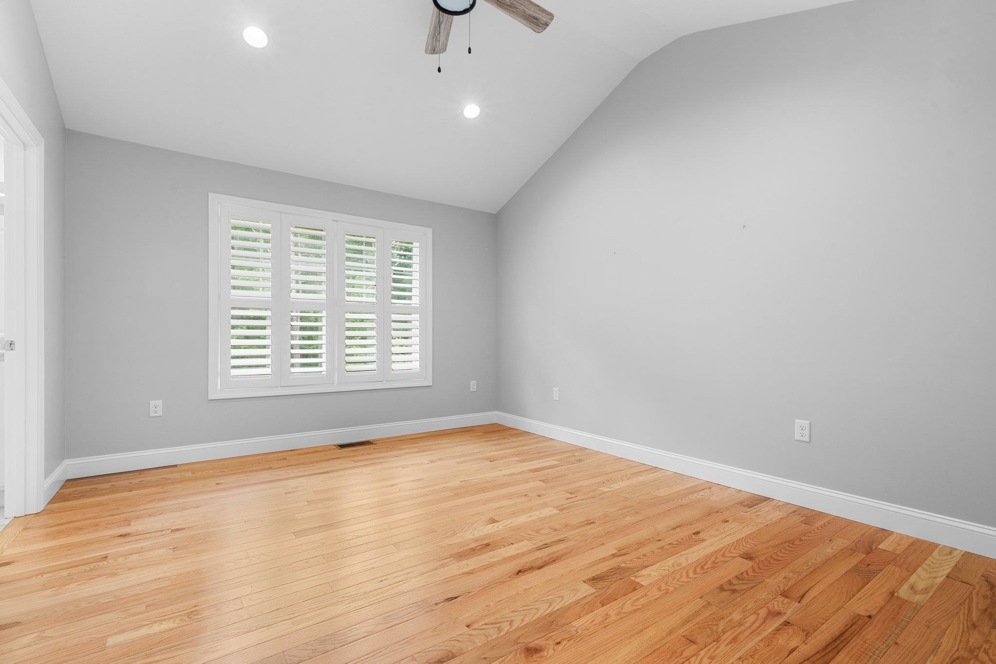 Primary ensuite with soaring ceilings and hardwood floors!