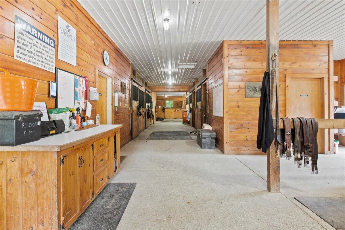 One of two barn aisles. Grooming stall at right, wash stall left