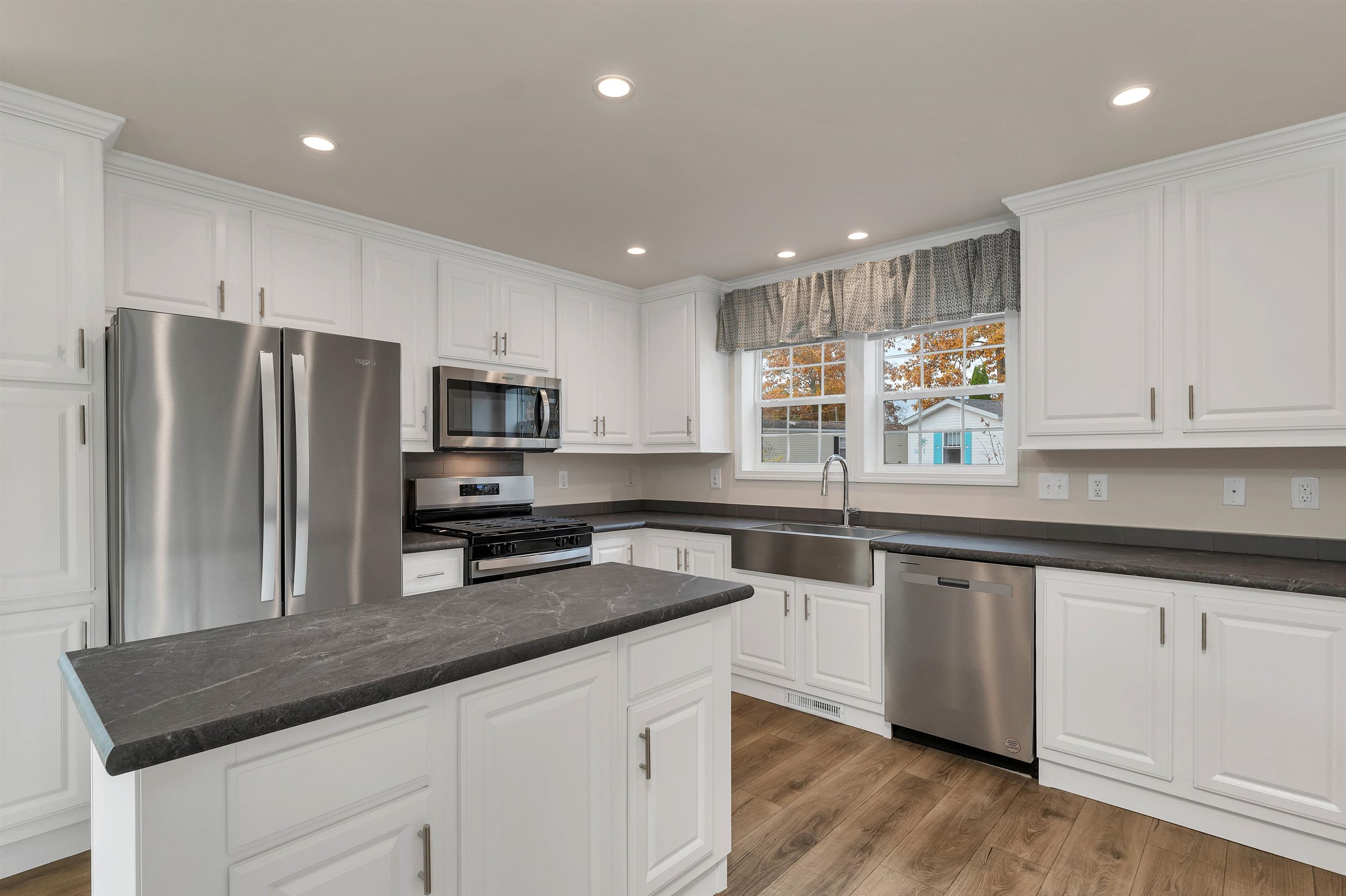 Hurry, this is the only brand-new manufactured home available in this park for this model, and is in one of the most well-established communities along the New Hampshire Seacoast. There are two-bedrooms, two-bathrooms, and a bonus room. Multiple upgrades have been added to this new home including tile back splash in the kitchen and crown molding throughout the house. Enter an amazing open concept kitchen with a center island, plenty cabinets, and all stainless-steel appliances. You will have a dedicated dining space next to a sliding glass door, a living room big enough for everyone, and an abundance of natural light on your corner lot. The washer and dryer already come installed in your dedicated laundry room with extra useable space. The master bedroom is big enough for a king size bed, has a large closet, a private master bath with a double sink vanity, extra bathroom cabinets, and a walk-in shower with a self-closing door. The second bedroom is almost equal in size and also has a large closet. There is a full-sized second bathroom that can be used for guests. Last you have a bonus room perfect for a den, office, home gym, craft room or storage. There will be a newly paved driveway big enough for 2 cars, central air conditioning, landscaping and an outdoor deck . This home is move in ready today. Smile, you just found your new home!