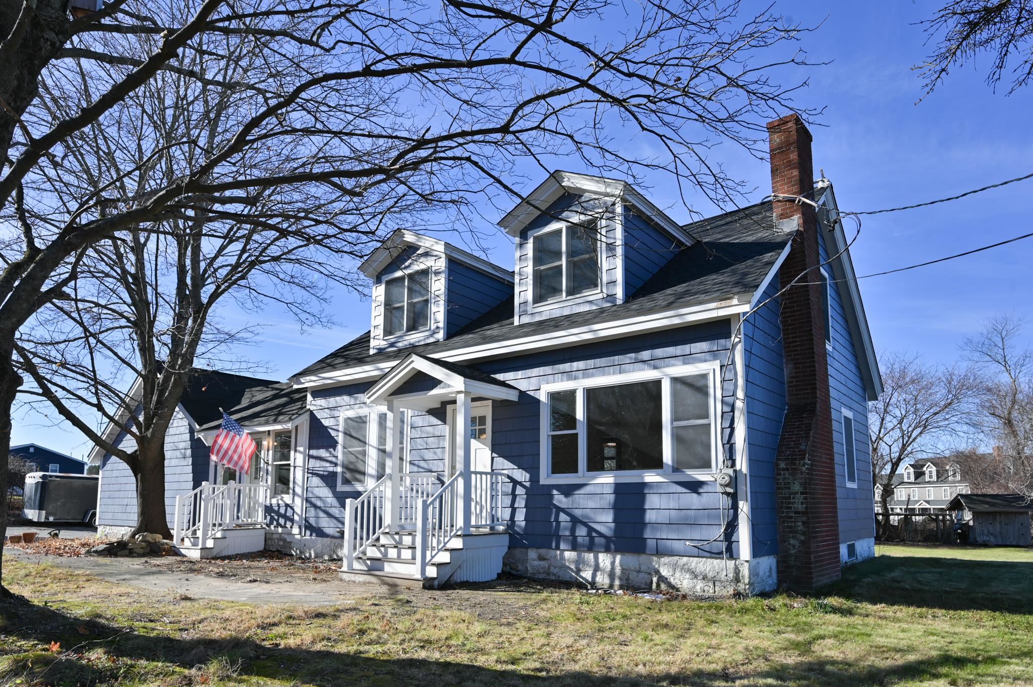 This lovely, 1,850 sq. foot three-bedroom, two-bathroom cape was once the 1796 Pelham Southeast Schoolhouse and sits on a one acre lot with fruit trees. The first floor renovated kitchen has fresh, white cabinets, marble backsplash and crown moldings. The kitchen leads into a large dining and living area which includes a wood burning fireplace with original soapstone hearth, wood floors and crown molding. A remodeled, full bath with gorgeous marble and a spacious bedroom including closet with laundry  hookups round out the first floor. A family room off the main floor features a forced hot air heating system and Harman pellet stove with sliders to the back yard. Upstairs you will find the master bedroom with an attached bath. The bath features a double headed marble shower, wainscoting on walls and teak floor. A 100-year old mahogany dresser serves as your vanity.  The barn has a concrete floor, parking for 4 cars and many other handyman features. The potting shed has a 6’ workbench, sink with running water and full electric. Home and barn have a perimeter drainage system creating a dry basement in all seasons. A true blend of character and convenience, this home is ready to welcome it's new owners. A must see!