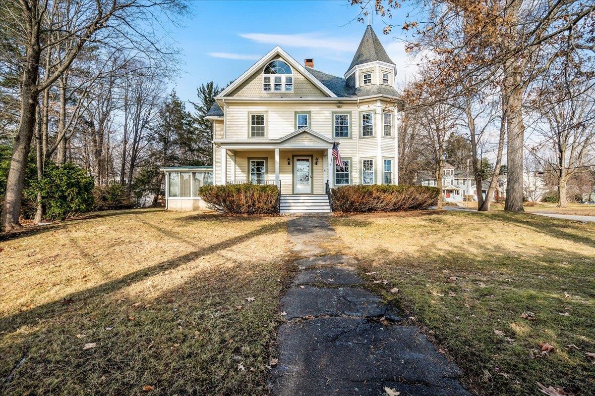Welcome to this stunning grand Victorian masterpiece in the heart of Nashua, in the desirable North End. This elegant home blends historic charm w/ modern amenities & unique architectural details creating a truly captivating living experience. As you step through the entryway, you’re greeted by intricate woodwork, high ceilings, & abundant natural light that fills every corner of the home. Just through the foyer a handsome carved newel post defines a regal staircase.  The main level features hardwood floors, an enormous, South-facing living room w/ fireplace & two bays of oversized, picturesque, windows, a formal dining room, main floor office & mudroom.  The updated, functional kitchen, has stainless appliances, white quartz countertops, an 8 ft center island, ample cabinetry, 6-burner gas stove w/ pot filler & a substantial eat-in kitchen space. Completing the kitchen is a wet bar w/ wine fridge & ice maker.  Upstairs,  you’ll discover four generous bedrooms, including a luxurious primary suite w/ two walk-in closets, a thoughtfully designed en-suite bathroom w/ marble floors & shower w/ separate cast iron claw foot soaking tub. A full-size attic provides superb storage space or the possibility of creating even more living space. Nestled on a lovely tree-lined corner lot in a convenient location near St. Christopher School, Greeley Park, Holman Stadium & Nashua’s vibrant downtown. You’ll enjoy the mature trees, welcoming porches, & a yard perfect for entertaining.