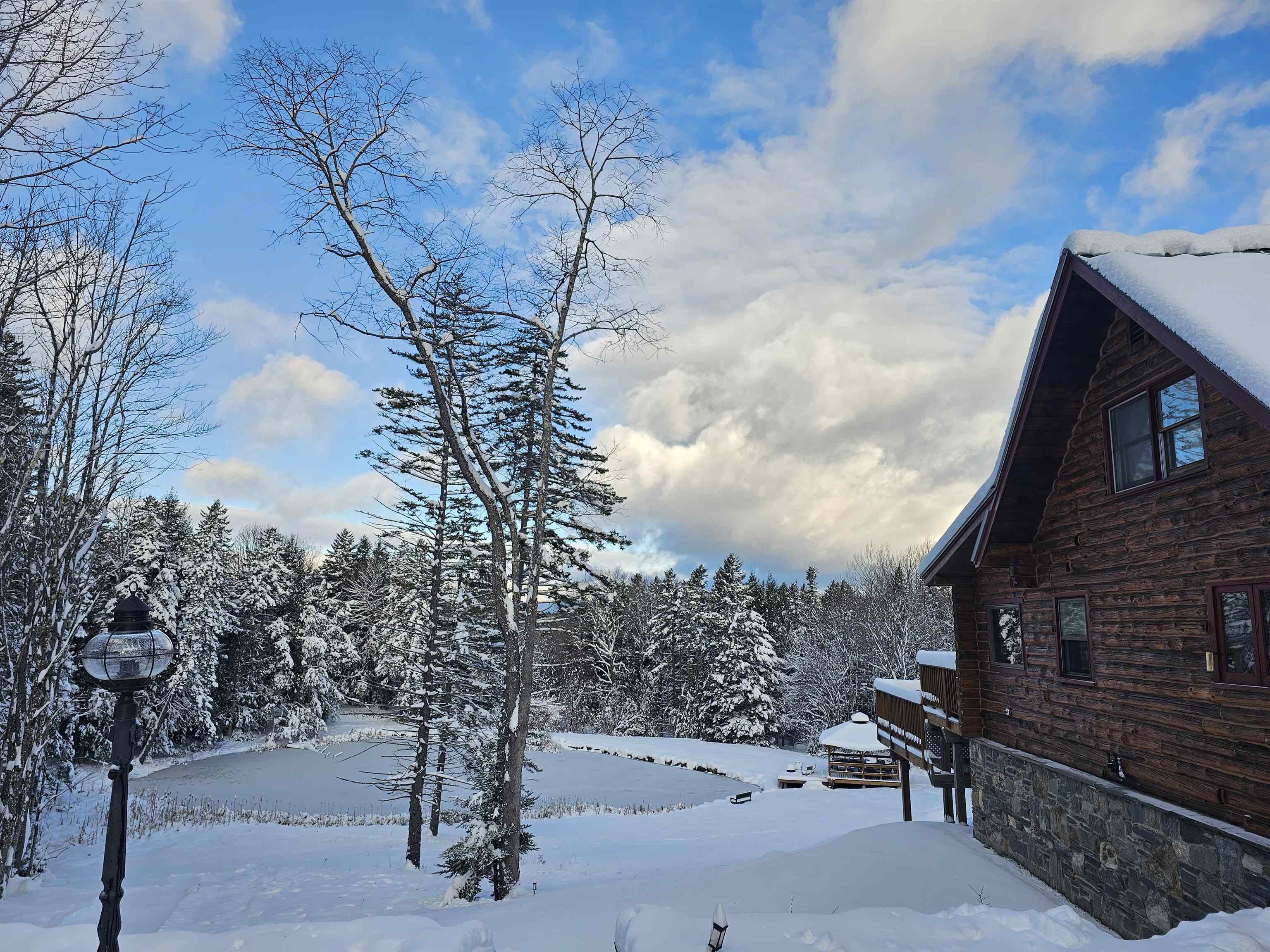Seeking an upscale but also rustic, Vermont retreat? Looking for privacy but convenience to amenities? Love a water feature and a mountain view? Need a place to host large gatherings but also cozy enough for a romantic weekend getaway? This is just the place. Tucked away on a private road sits this spacious 4 bedroom, 3.5 bath, true log home with an excellent layout over 3 finished floors. All you need for a weekend, season or lifetime of memories in Vermont is here at your fingertips. This beautifully renovated home hosts too many features and updates to list including open concept spaces, vaulted living room with brick hearth, wood floors, sunroom, main floor primary suite with walk-in closet, bathroom with 2 showers and double sinks! The lower level family room, bedroom, bath and overflow spaces accommodate many. Upstairs find 2 generous guest beds, bath and loft with exposed brick and high ceilings . The exterior is just as special as the interior with multi level tiered decks ( ready and wired for your hot tub) facing the Mount Snow trails and overlooking the pond below. Covered porch, firepit area and 2 car garage! Follow the stone path down to the pond house with power, lighting and ceiling fan to enjoy summer nights or light the fire for smores as you skate on your frozen pond in the winter. Perfectly situated between Wilmington and Dover, this 4.9-acre haven provides space, privacy and the best of Vermont four season living. This is a must see property.