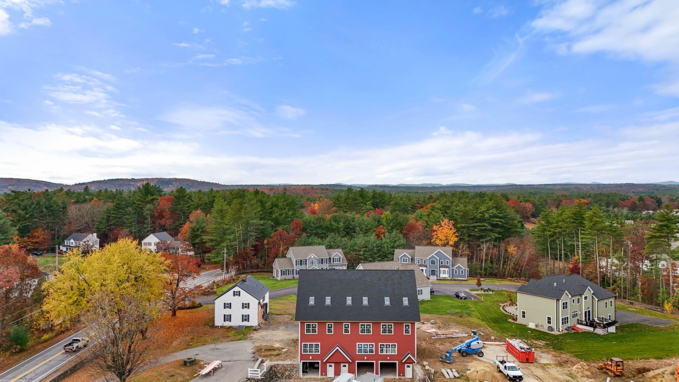 Discover refined living in this extraordinary barndominium-style townhome, where historic charm meets contemporary luxury. This meticulously crafted residence offers 2,200 square feet of thoughtfully designed living space across three levels, masterfully converted from an iconic red barn on the Hollis /Nashua border. The heart of the home showcases an impressive open-concept design, where gleaming oak hardwood floors unite the living, dining, and gourmet kitchen spaces. The kitchen captivates with sleek quartz countertops and a generous island perfect for casual dining and entertaining. Ascend to find two generously proportioned bedrooms complemented by a full bath and convenient laundry facilities. The crowning jewel awaits on the third floor – a stunning primary suite featuring dramatic vaulted ceilings punctuated by skylights, a spa-inspired ensuite, and a walk-in closet. This residence enjoys proximity to the serene, Nashua River Rail Trail, Yudicky Farm Conservation Area and The Dunstable Rural land Trust, while golf enthusiasts will appreciate the nearby Sky Meadow and Overlook Country Clubs.  Early buyers have the unique opportunity to personalize finishes and color schemes in this distinguished address. Welcome to a home where heritage and luxury coalesce to create an unparalleled living experience. Seller welcomes offers with requests for buyer concessions!