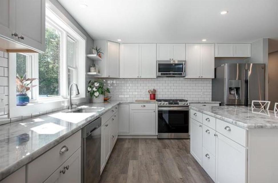 quartz countertops and light bright cabinets make this a focal place of the home