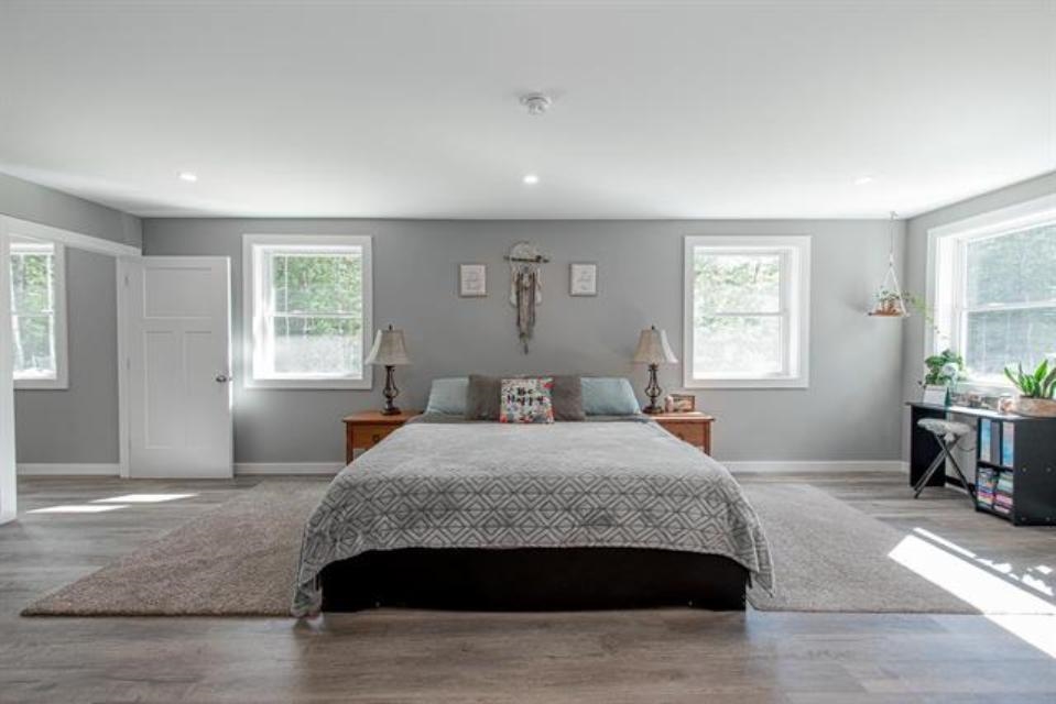 this bright and large primary features a spa like bathroom and oversized walk in closet