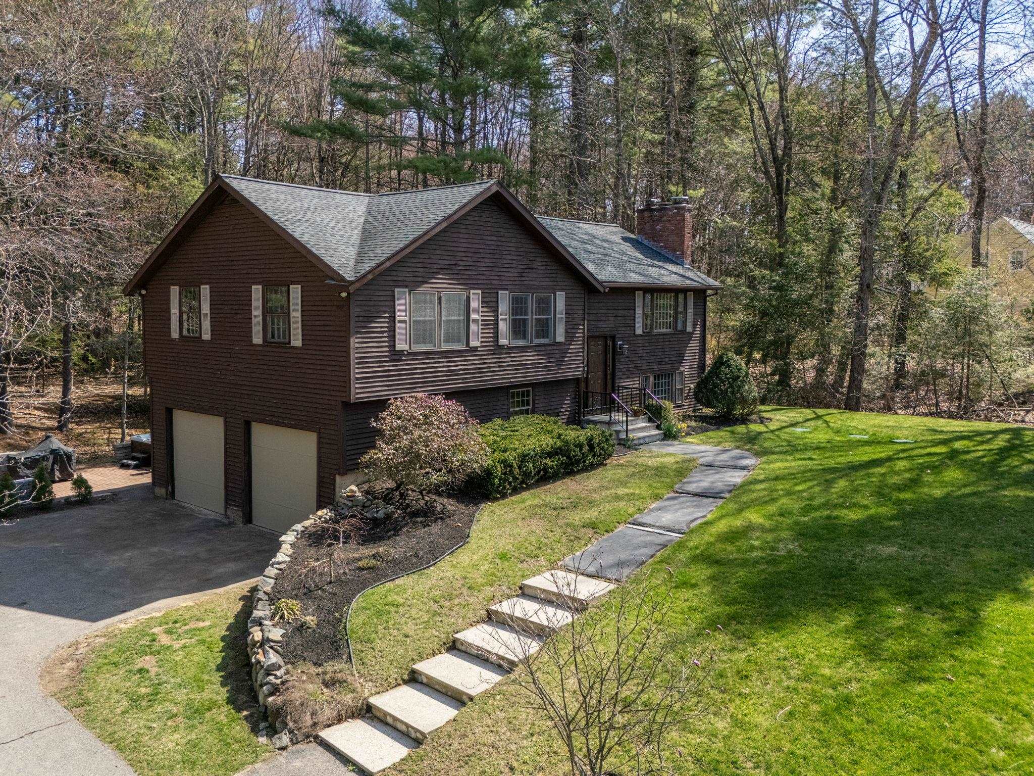 WELCOME HOME TO 12 Butterfield Lane located in the heart of Stratham in one of its most sought after areas - close to all town amenities, schools, shopping areas, restaurants, & all commuter routes. Approach the home & you are greeted with its wonderful curb appeal perched up on a knoll, privately set back from the road on 1 wooded acre. Out back, enjoy your new composite deck overlooking the fire pit & stream & take in the solitude; or relax in the hot tub with surround patio. Step inside this bright home where you are welcomed with an inviting open concept floor plan. The kitchen is beautifully appointed with high end stainless appliances, stunning cabinetry & tile backsplash. With the open kitchen, dining & living space, this home is perfect for entertaining & relaxing with family.  There are three bedrooms upstairs with two beautifully appointed baths; the large primary having its own gorgeous bath. Downstairs find a large recreation room with built-ins & a seating "nook" making for an additional family room/tv room or however you choose to use it; complete with a wood burning stove to add to the coziness.  Also, you will find the perfect bright office/playroom with a wall of built-ins. Lots of utility. This home has plenty new: a 4 bedroom septic, roof, carpet, front door, deck, painting. This home has central air & and air purification system. Don’t miss the opportunity to call this home.  SHOWINGS BEGIN AT OPEN HOUSES ON FRI 4/25 4-6PM AND SAT & SUN 4/26 & 4/27 11-1PM.