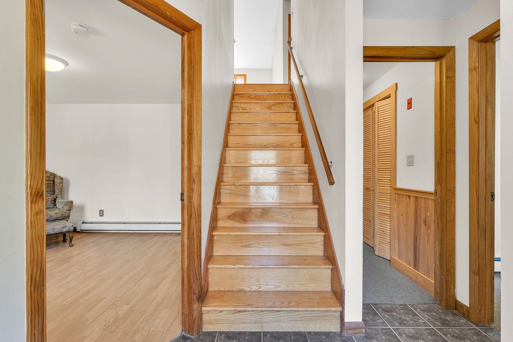 Stairs to main level, bedroom to left and finished living area straight ahead