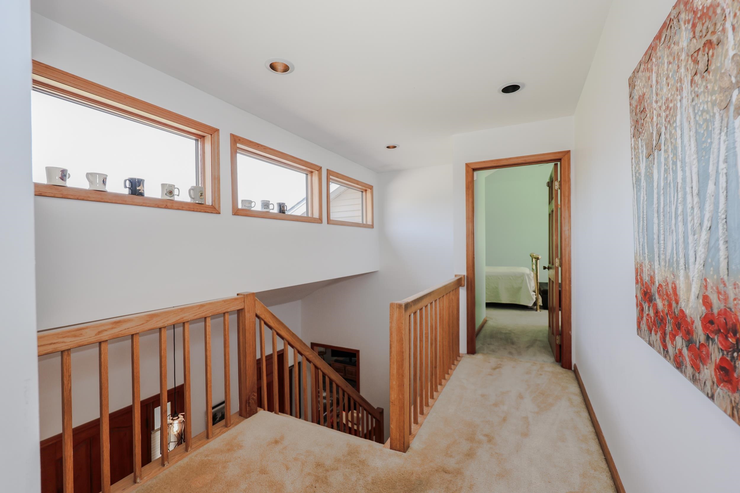 Upstairs hallway leading to primary bedroom