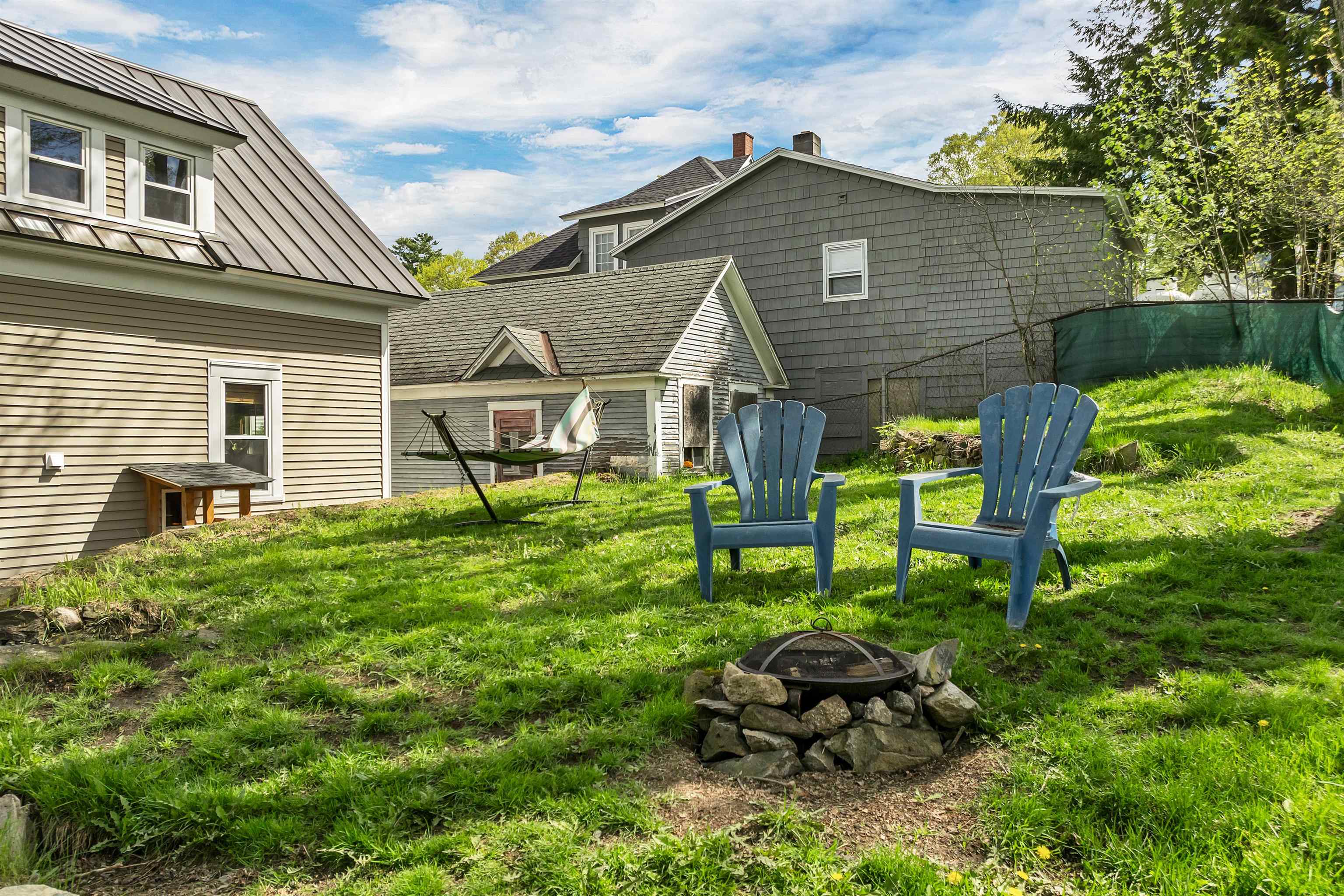 Fenced in back yard with fire pit 23169339