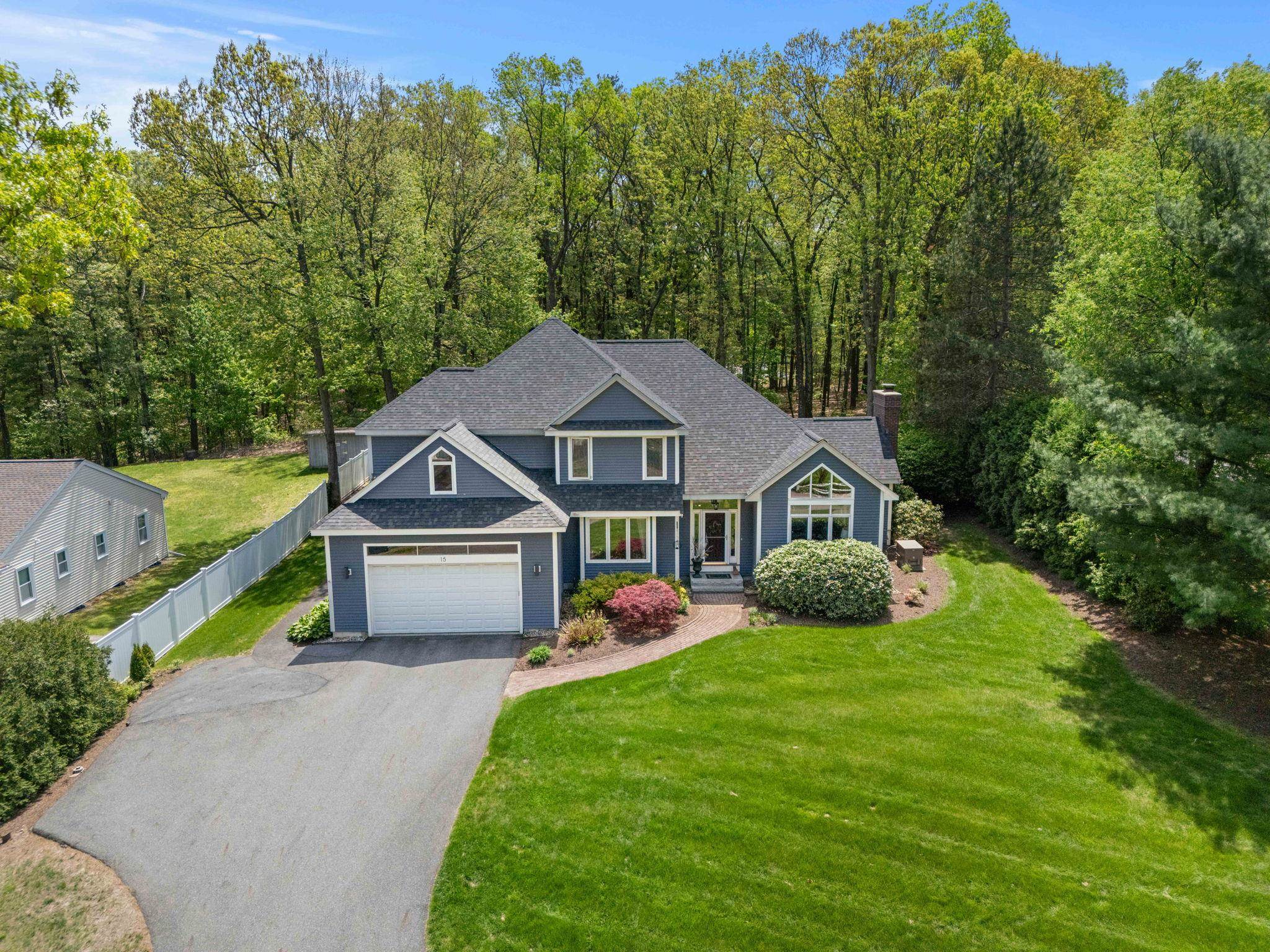 Welcome to this stunning contemporary residence nestled in one of Nashua’s most desirable neighborhoods, just minutes over the Massachusetts border—perfect for commuters seeking luxury and convenience. Situated near the prestigious Nashua Country Club, this expansive home blends modern design with timeless comfort. Step inside to discover a bright and open-concept granite kitchen that flows seamlessly into a vaulted ceiling living room featuring a cozy gas fireplace and walls of windows that bathe the space in natural light. The formal dining room is ideal for elegant entertaining, while the first-floor office with French doors offers a quiet retreat for remote work. A versatile first-floor bedroom sits adjacent to a beautifully appointed full bath with a tiled shower—ideal for guests or multi-generational living. Upstairs, retreat to the oversized primary suite with dual walk-in closets and a spa-inspired bathroom complete with a tiled shower and a luxurious Bain Ultra soaking tub. Two additional spacious bedrooms share a Jack and Jill bathroom, perfect for growing families. The finished lower level is an entertainer’s dream with a home theater, bar, and pool table area, creating the ultimate space for gatherings and relaxation. Enjoy outdoor living in the flat backyard featuring a patio, shed, and irrigation system for easy maintenance. Additional highlights include public water and sewer, natural gas, central A/C, a whole-house generator, and new roof for peace of mind.