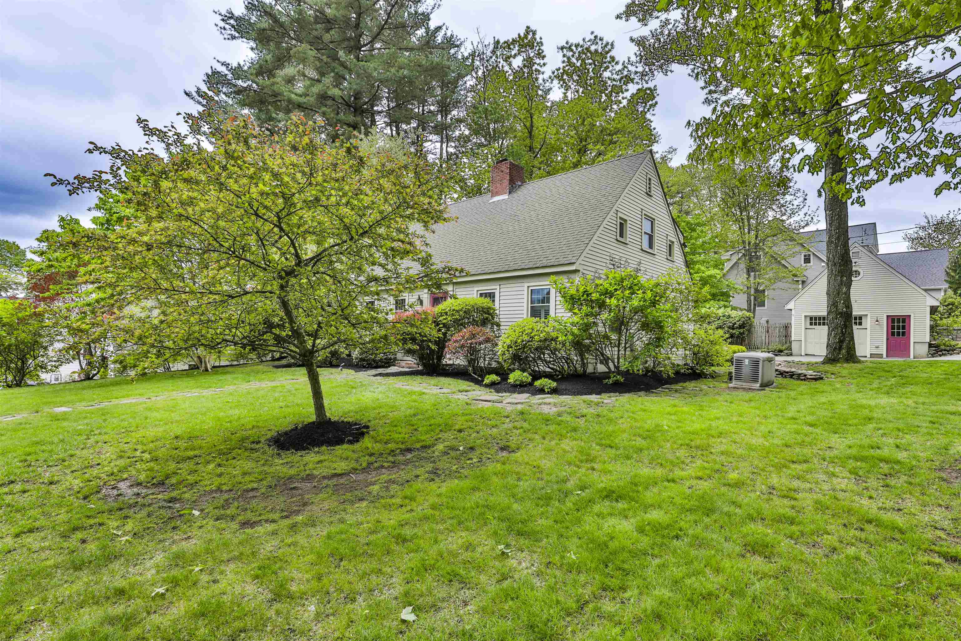 Welcome to this beautiful custom cape situated on an exquisitly landscaped 1/2 acre lot in the desirable North End of Nashua. Built in 1939 this home exudes quality and charm throughout! The efficient kitchen with cherry cabinets and granite countertops open to the large dining room. Around the corner you find a wonderfu pantry and cozy family room with cathedral ceiling, gas fireplace and three walls of windows bringing the outside in. Step down to the large fireplaced living room with built-in bookcases, a full bath, first floor bedroom and seperate office or 5th bedroom. Upstairs you will find the primary bedroom offering a private bath, upstairs laundry, walkin closet with built-ins.  A family bath and two more bedrooms round off the upper level.  The lower level provides a finished space for exercise room or play area, second laundry and so much storage. There is a whole house generator too.