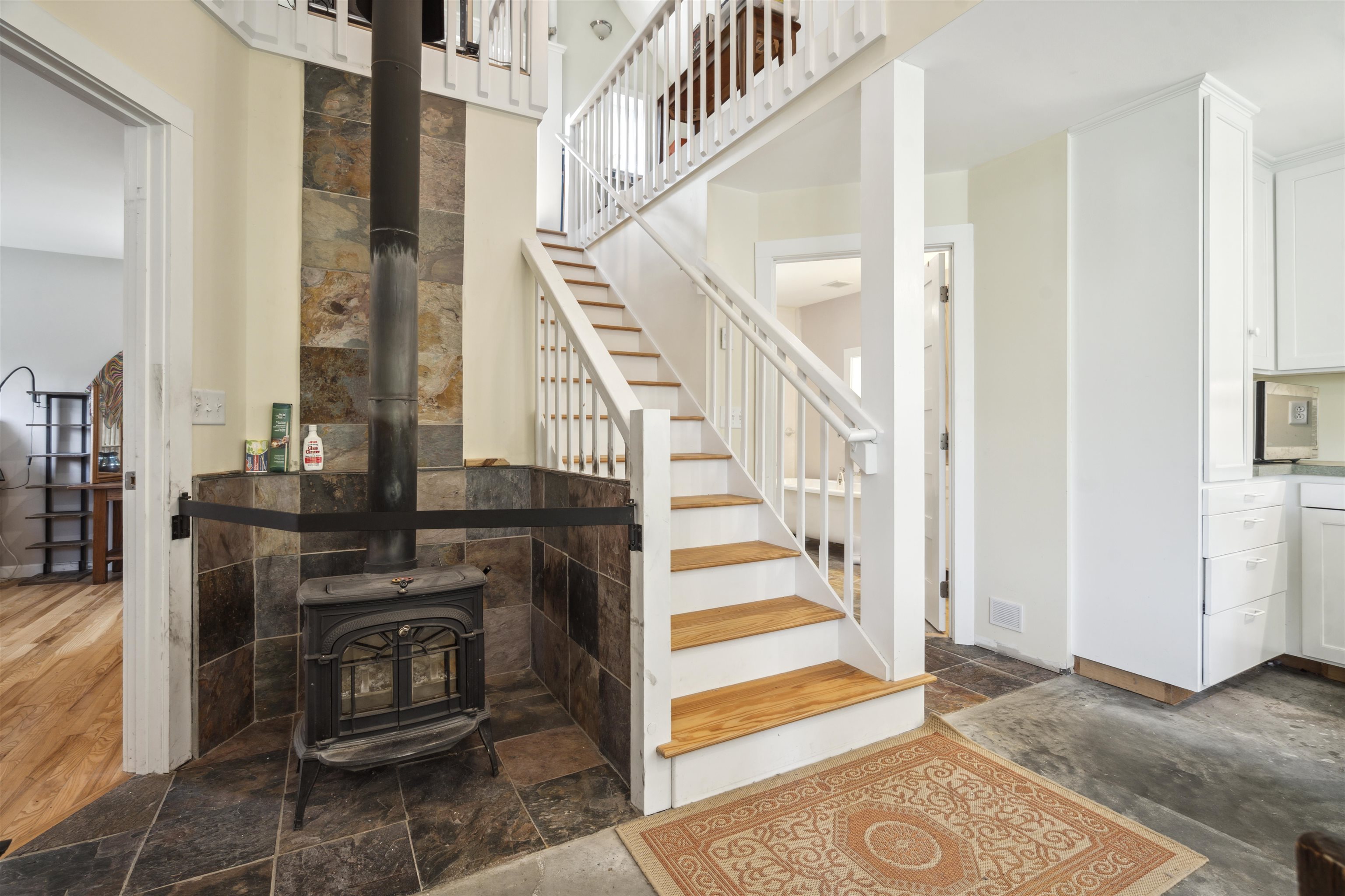 Woodstove and stairway to upstairs
