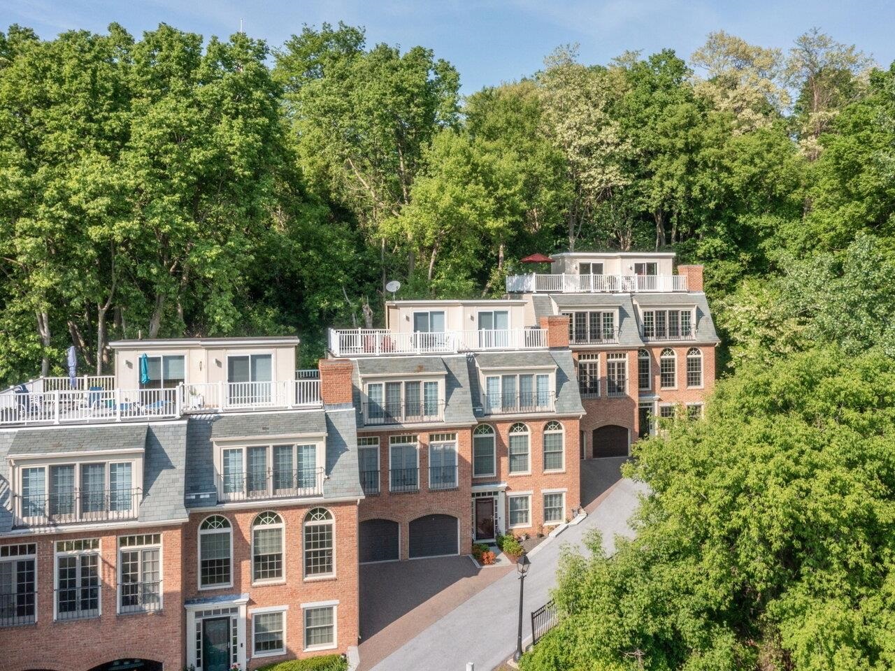 Far and away, the most exciting condominium to hit the Vermont real estate market this year! This one-of-a-kind luxury waterfront townhouse, overlooking beautiful Burlington Harbor, offers the ultimate in downtown living. This exclusive 200 Lake Street Condominium is one of only three units with 4 levels of living space! Each level features high-end finishes and desirable amenities, all with a panoramic westerly view of Lake Champlain & the Adirondack Mountains. The lower level of this stunning home is comprised of a heated two-car garage and finished bonus room with full bath. With its own private entrance, it makes a wonderful guest space, office, or den. One floor up is the main level with a stylish, open-concept chef's kitchen and sun-filled dining room, flanked by a spacious living room with gas fireplace, hardwood floors, and stunning Palladian windows looking out onto the city's Waterfront Park and Harbor. The third level boasts a primary bedroom suite that includes a lovely custom bath, as well as a guest bedroom with an en suite bath. The fourth level is what sets this townhome apart from the rest, featuring a wonderful sitting room with sliders leading to a glorious, private rooftop deck. Enjoy magical sunsets, barbecues, and long summer afternoons hanging out on your own top of the world deck space! Downtown shops, parks, bike path, eateries, theatre, festivals, and more are all at your fingertips. This exclusive luxury waterfront condo is a must see!
