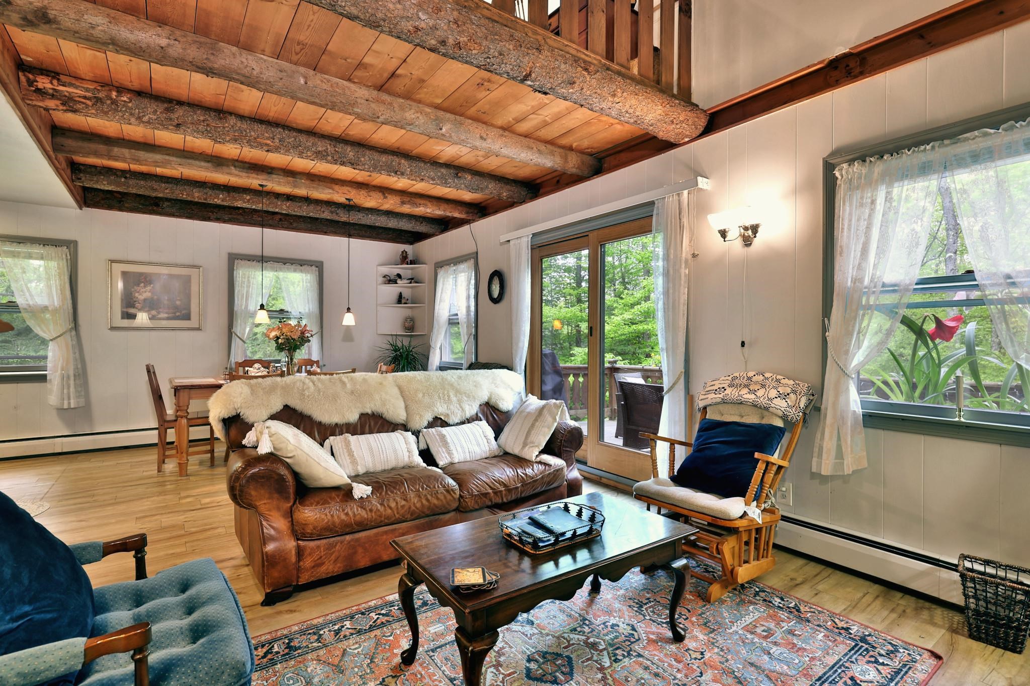 This beautifully updated 4-bedroom chalet-style home is nestled on a serene 1.4-acre lot, just minutes from the heart of Weston, the iconic Vermont Country Store, and the renowned Weston Playhouse. Featuring a freshly painted interior, newly finished walkout basement, and a new Harman pellet stove that efficiently heats the main level and upper loft, this home is move-in ready and perfect for year-round enjoyment. A standby generator provides peace of mind by powering most of the home during outages. Step outside to enjoy a spacious deck off the living room with views of the front yard, or relax on the private balcony off the primary bedroom overlooking the tranquil backyard. The property is thoughtfully landscaped and offers a peaceful retreat with a babbling brook, and a storage outbuilding. A new septic system installed in 2020 adds to the home's value and convenience. Ideally located near four major ski areas and a variety of local attractions, this home is perfect as a primary residence or a charming family getaway - offering the very best of Vermont living in all four seasons.