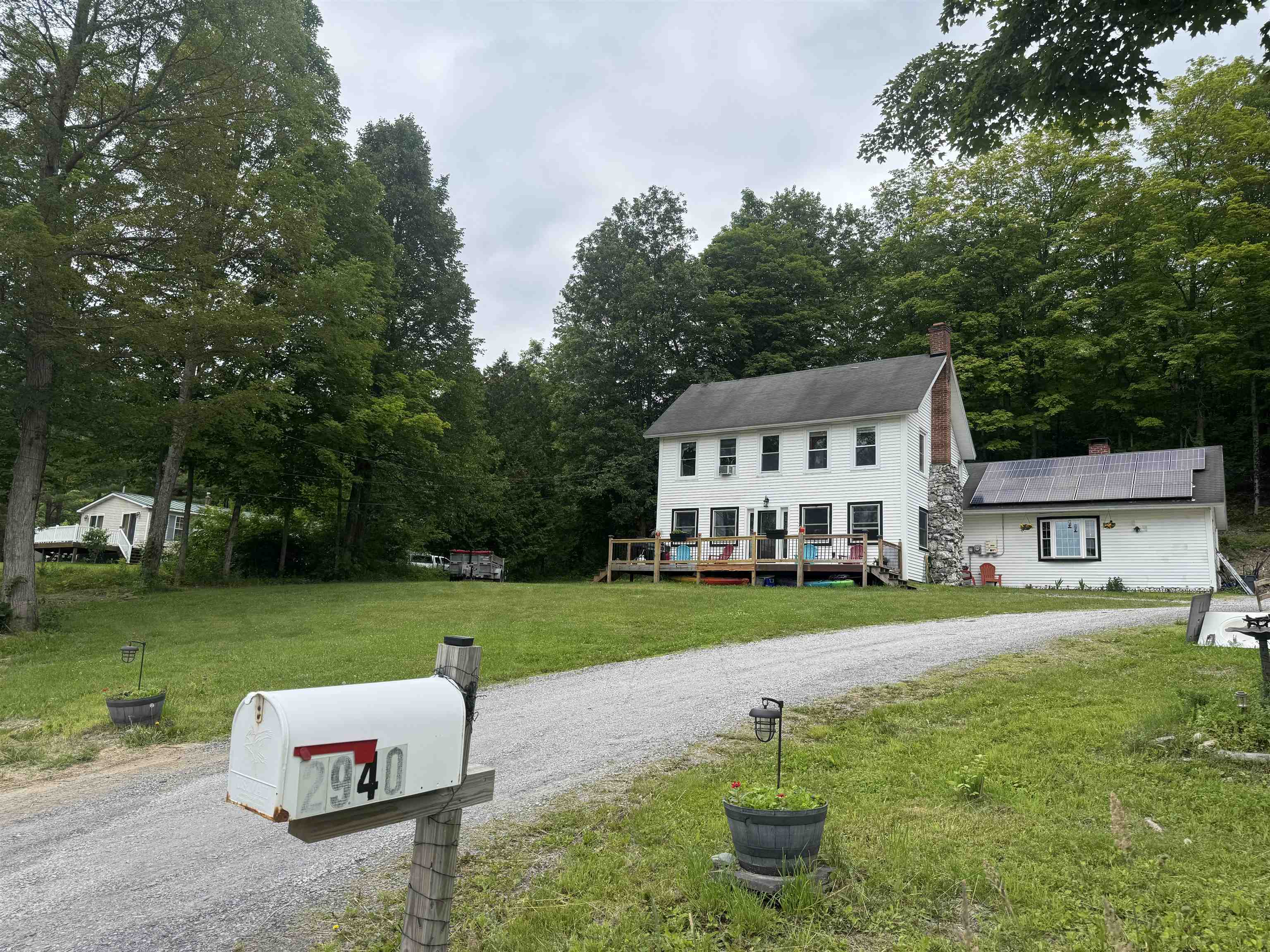 A charming 1880, beautifully preserved colonial home on almost an acre of land. This property offers the ultimate lakeside lifestyle, complete with deeded lake frontage, your own dock space with boat lift. This home offers plenty of space for your family and friends.  Enter into the foyer and then into the kitchen which flows seamlessly into the dining area and into the spacious living room, with a floor-to-ceiling stone fireplace which creates a warm focal point. Curl up on a cold night and enjoy the ambiance.  Also, on the main floor is a Master bedroom with en-suite bath, laundry room with half bath, and utility room, while upstairs you’ll find two additional bedrooms, a dedicated office/flex space, storage area, and a full bathroom. Hardwood and pine board floors add timeless character throughout. Sit on the deck or by the campfire, relax and enjoy the sunsets! Enjoy all the lake has to offer; boating, fishing, kayaking, swimming and so much more.   Not far is Castleton University, State Park, Crystal Lake, Killington Ski Resort, and/ or explore nearby hiking and snowmobile trails. A rare opportunity to enjoy year-round recreation in a classic lakeside home!