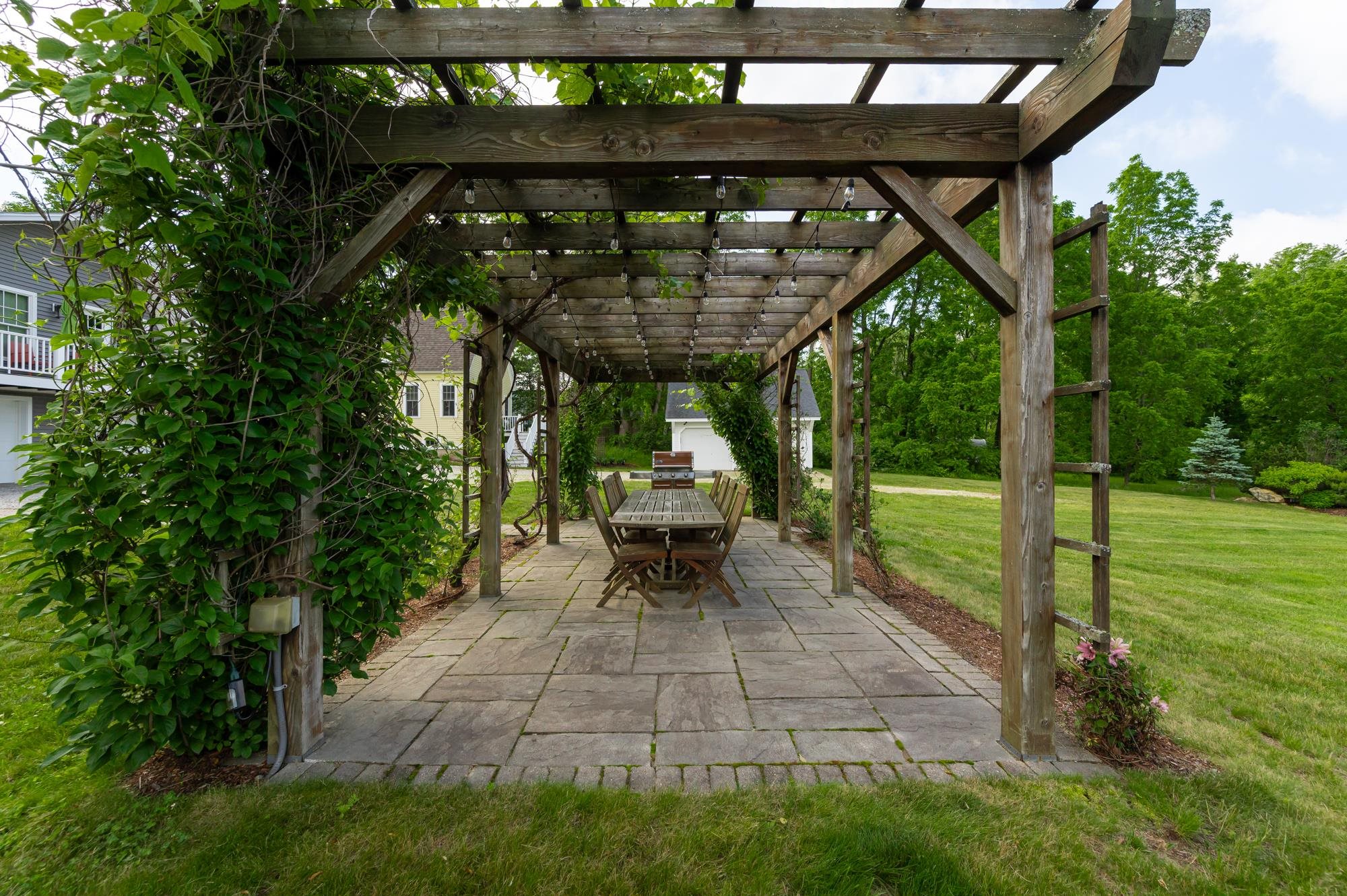 Lighted pergola with seating and grill