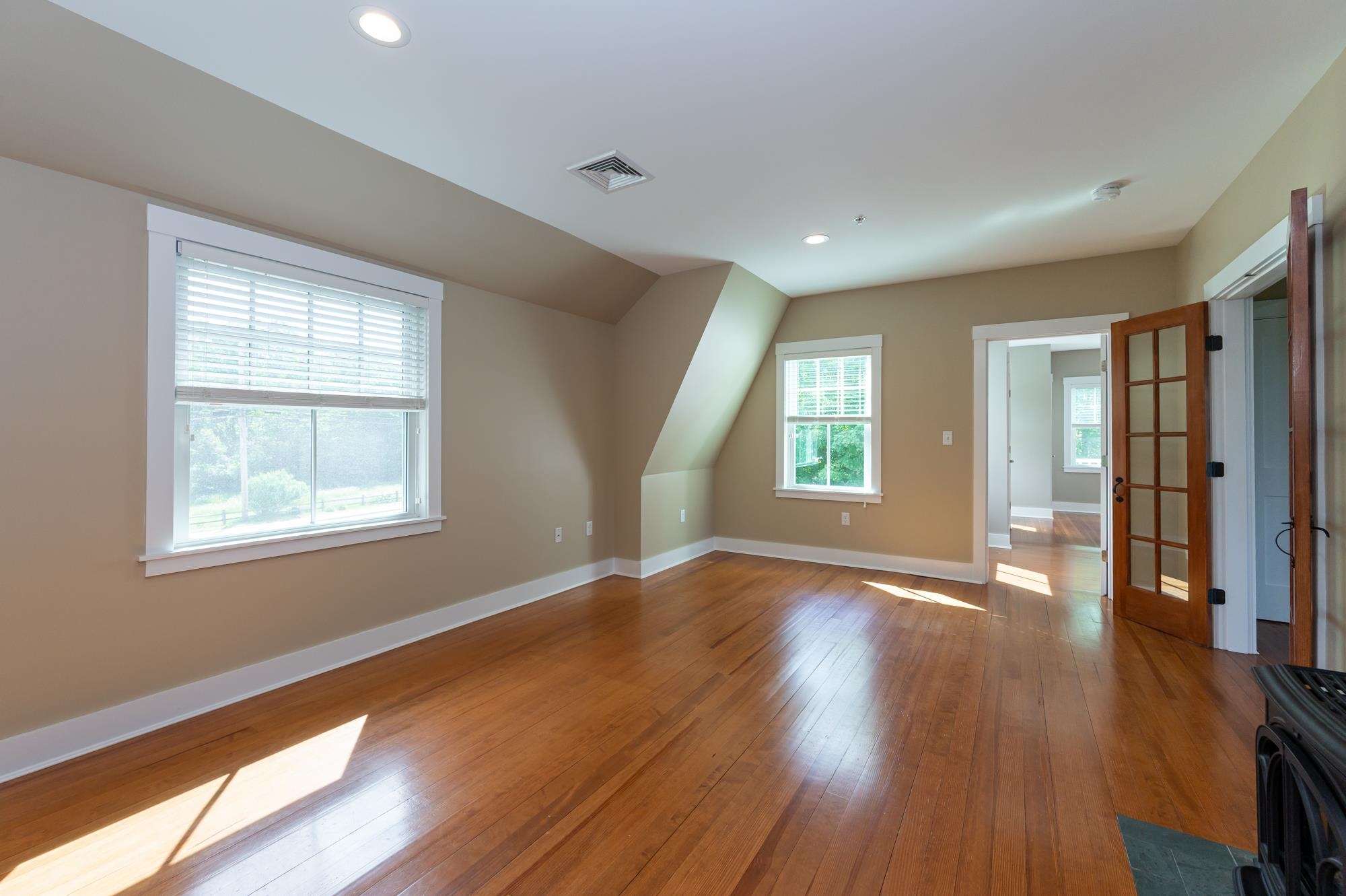 Warm maple floors throughout living space and bedrooms