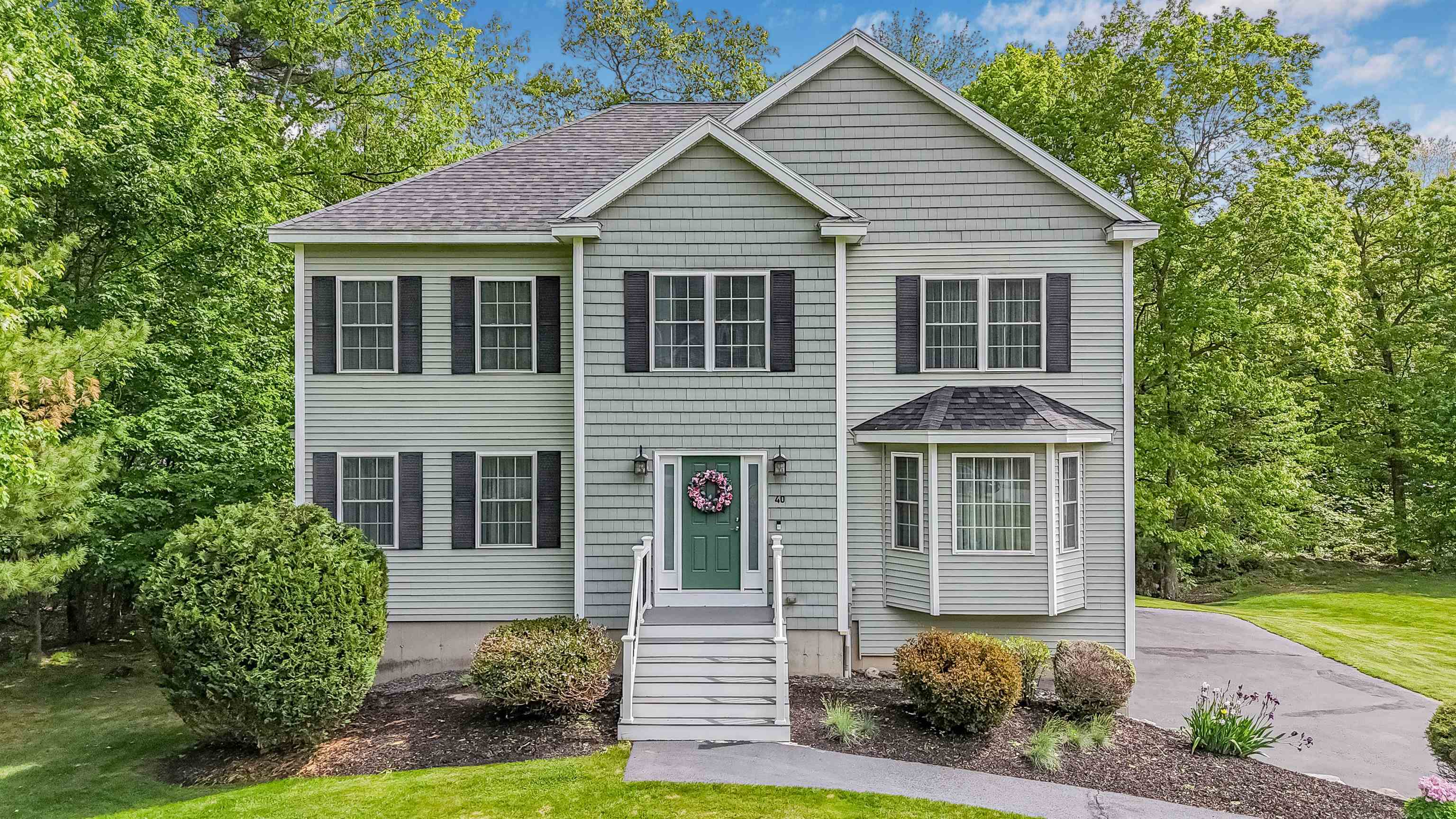 Welcome to 40 Jackman Ridge Road — a beautifully maintained Colonial built in 2009, located in Windham’s sought-after Butterfield Estates. This elegant 3-bedroom, 3-bathroom home offers 2,800 sq ft of thoughtfully designed living space on a professionally landscaped 0.72-acre lot.  The sun-filled main level features gleaming hardwood floors and an open-concept layout, including a granite kitchen with center island, pantry, stainless steel appliances and under cabinet lighting— ideal for both everyday living and entertaining. Unwind year-round in the finished sunroom, which overlooks your private backyard oasis.  Upstairs, the spacious primary suite features a recently updated en suite bath with a walk-in shower, leathered granite double vanity and generous closet space. Two additional bedrooms offer flexibility for family, guests, or office space. A walk-up attic and unfinished basement provide excellent storage or future expansion options.  Additional highlights include a 2-car garage, irrigation system, additional storage under the sunroom and convenient access to highways, walking trails, and town amenities. A perfect blend of timeless comfort and modern touches in one of Windham’s most desirable neighborhoods.  Showings begin Friday at 11 a.m.