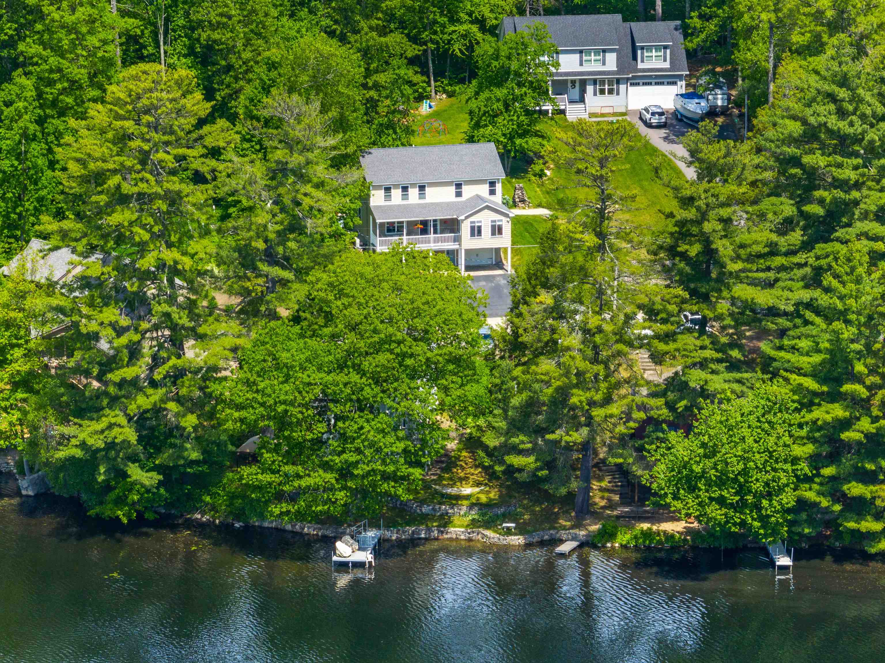 Welcome to this like-new 2015 Garrison-style home offering scenic water views and deeded right-of-way access to your own personal dock on tranquil Rock Pond! Nestled in a peaceful setting, this 3-bedroom, 3-bathroom home features a beautifully landscaped yard, a covered porch with pond views, and modern finishes throughout. Step inside to gleaming hardwood floors, a spacious dining room, cozy living room, and a sunroom that brings the outdoors in. The kitchen boasts granite countertops, stainless steel appliances, and a bar-style counter perfect for entertaining. Upstairs, the generous primary suite includes a 3/4 bath and walk-in closet. Two additional bright bedrooms and a full bath complete the second floor. The finished lower level offers a welcoming entry, office space, utility room, and garage access. Enjoy year-round comfort with central AC. Rock Pond spans 42 acres with nearly two miles of shoreline and is home to a variety of fish—ideal for nature lovers and anglers alike. Additional features include a shed and inviting outdoor spaces. Showings begin at the Open House: Sunday 12PM–3PM. Don’t miss your chance to own this serene waterfront retreat!