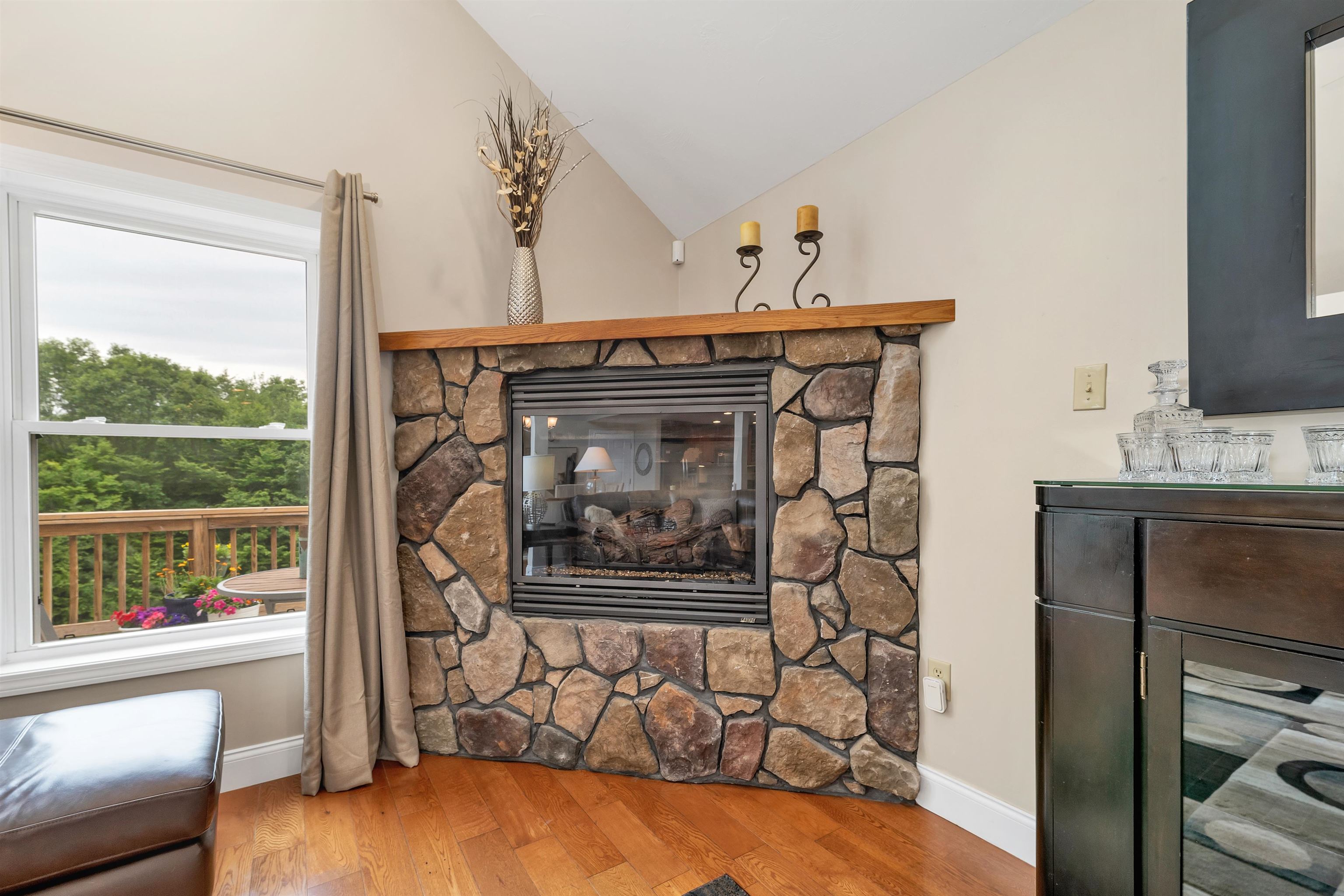 THE FIREPLACE, GLASS DOORS AND WINDOWS ARE HIGHLIGHTS OF THE LIVING AREAS.