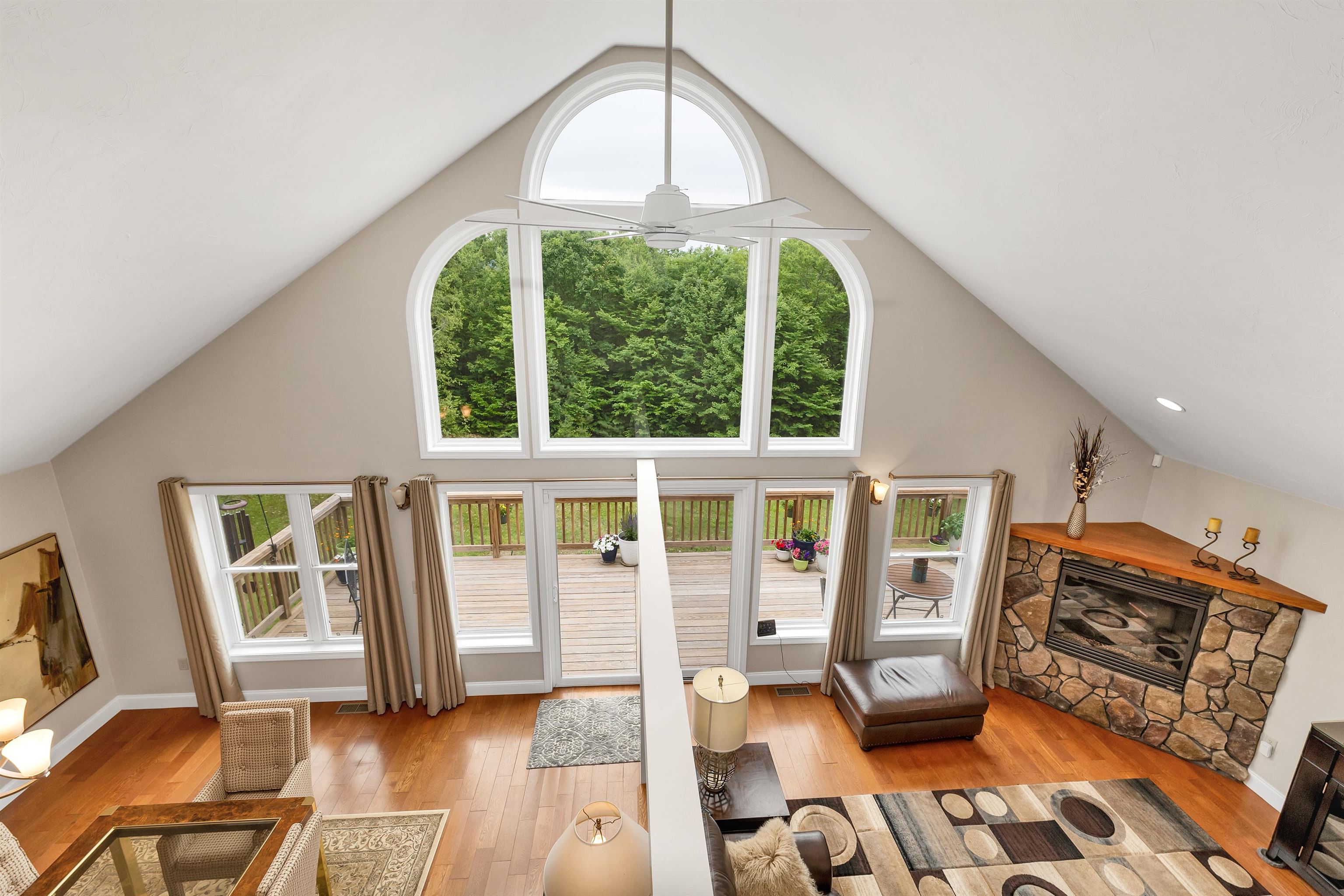 IT LOOKS DOWN TO THE DINING AND LIVING AREAS . .