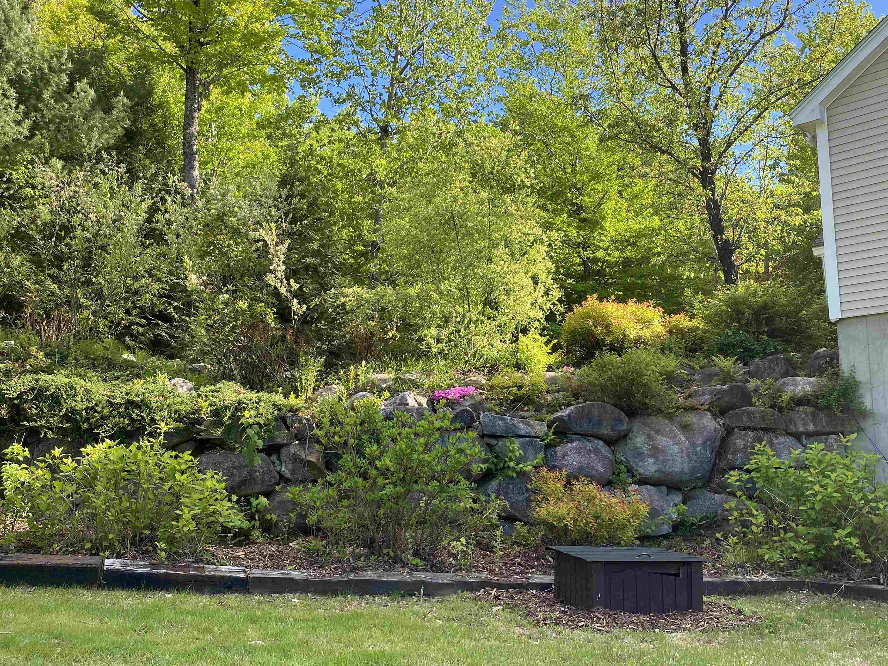 GARDENS INCLUDE VEGETABLES, PERENNIALS, AND FLOWERING BUSHES.