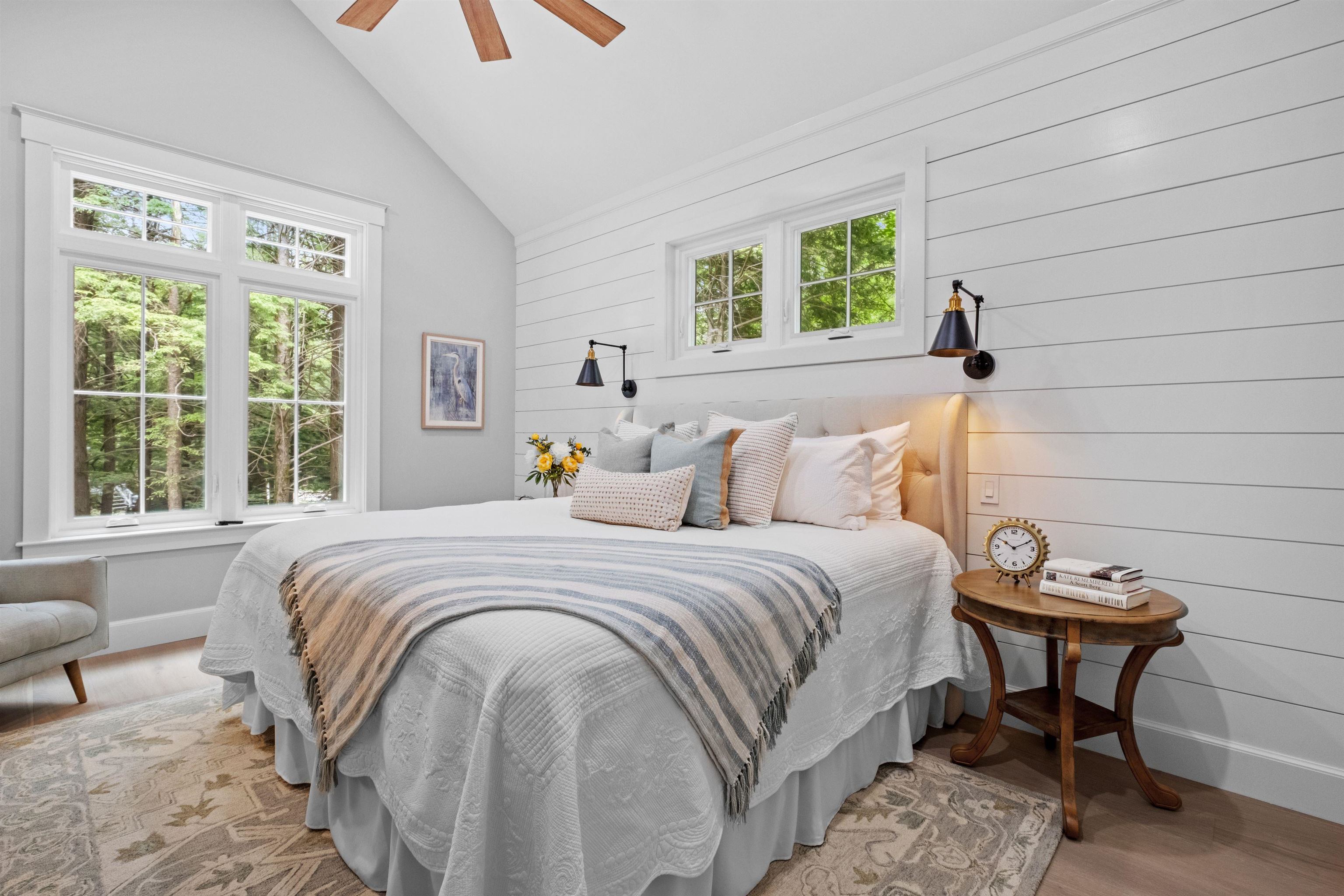 Primary bedroom ensuite with shiplap accent wall cathedral ceilings