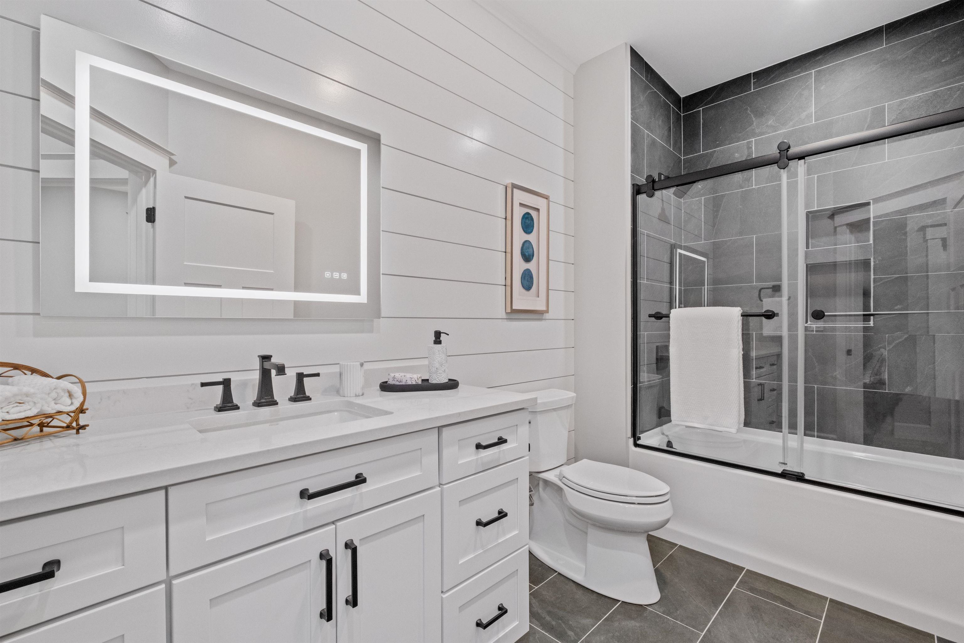 Second bath, includes glass enclosure, soft touch mirror