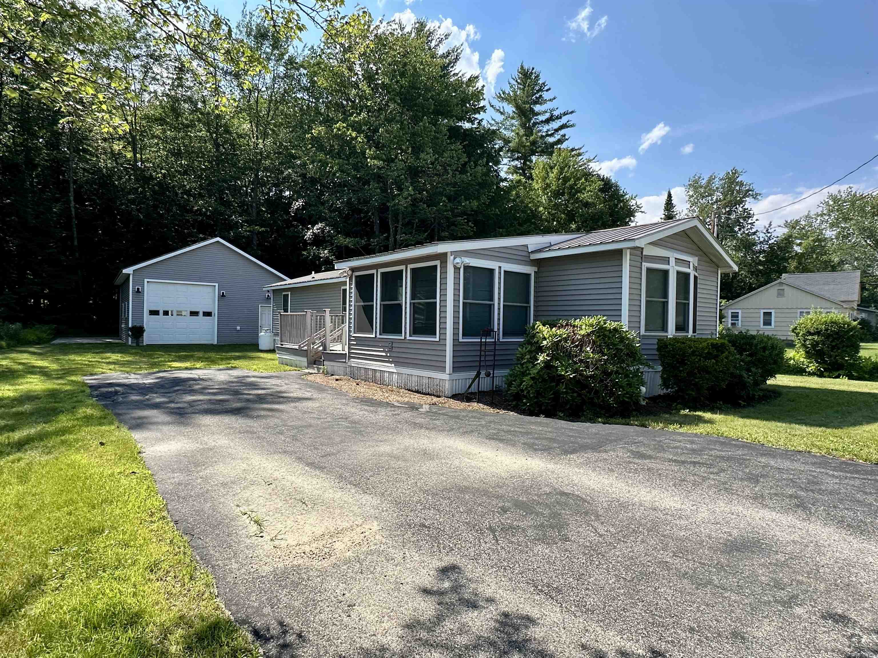Welcome to 56 Quint Street – this well-maintained property offers the perfect blend of comfort and convenience. Ideally located just minutes from North Conway Village, Cranmore Mountain, Attitash, snowmobile trails and the Saco River, this home is perfect as a primary residence, vacation getaway, or investment property. Inside, you’ll find an open kitchen and living areas, 2 good sized bedrooms, laundry area and full bath. Fantastic upgrades include the newer mini-split system for AC & added heat source, updated vinyl siding, plumbing and insulation. Public water/sewer. Enjoy peaceful mornings on the newer deck or entertain guests in the private backyard. With the added HUGE 25x30 garage to protect your cars/toys, this home checks all the boxes for mountain living. Don’t miss your chance to own a slice of the Mount Washington Valley lifestyle!