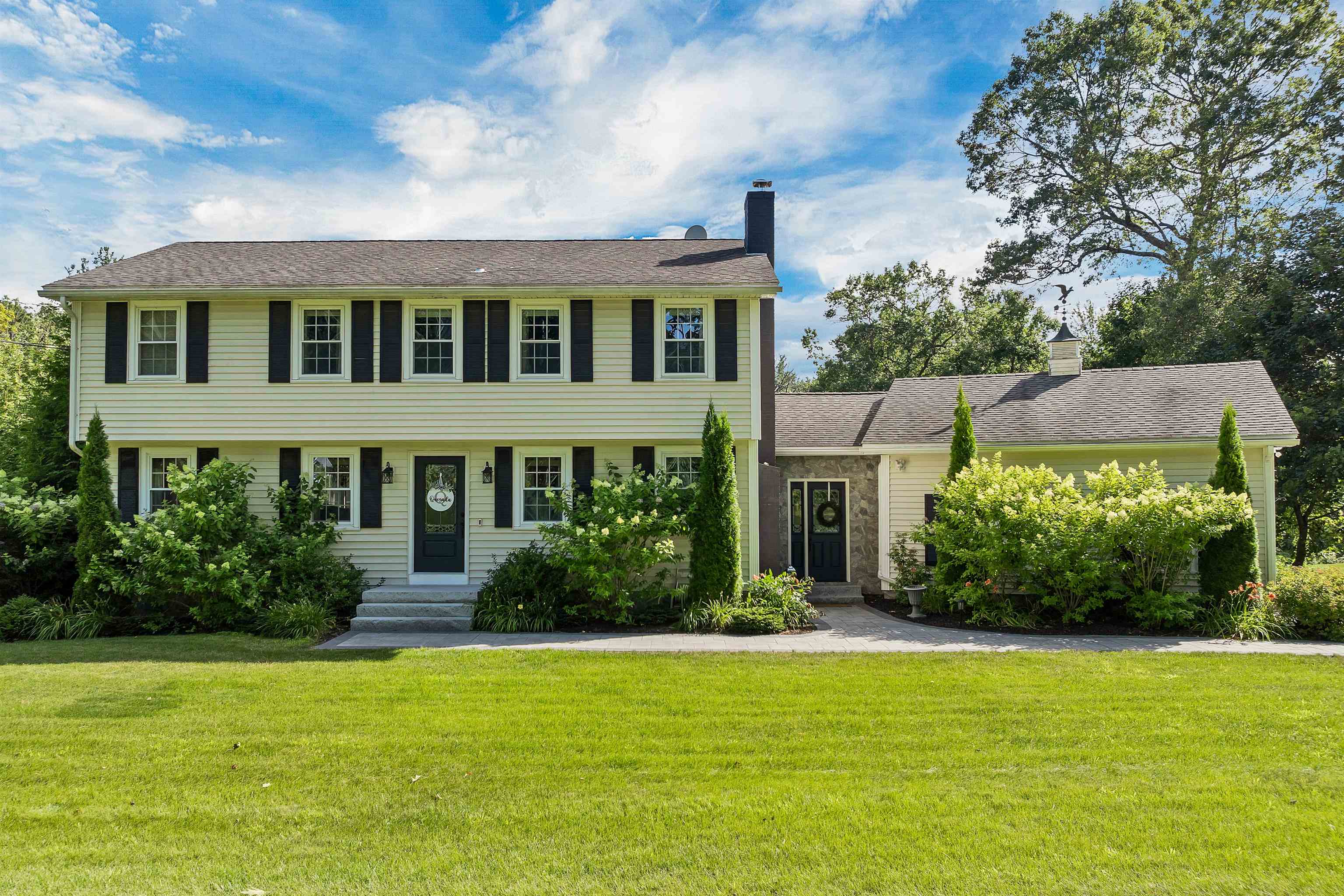 Welcome to 149 Londonderry Road in scenic Windham, NH—a home that delivers the perfect mix of comfort, character, and stylish updates. Step inside and you’ll find gorgeous hardwood floors flowing through much of the home, creating a warm and inviting feel. The kitchen is designed to impress, featuring beautiful cabinetry, granite countertops, classic white subway tile, and stainless steel appliances—including a Viking 6-burner stove that’s ready to handle anything from pancake breakfasts to holiday feasts. The oversized island offers plenty of space to gather, prep, and enjoy.  A full tiled bathroom on the first floor adds convenience, while the converted breezeway-turned-bar is an entertainer’s dream, complete with built-in storage and a fun, flexible vibe. Head downstairs to the finished basement and discover a cozy movie setup, additional office space, and a walk-in closet. The second floor offers four spacious bedrooms, two full bathrooms, and the ultimate time-saver—second-floor laundry!  Enjoy year-round comfort with central A/C and central vacuum. The fully fenced backyard is an outdoor oasis with a newer paver patio, a large barn for extra storage, and plenty of space to relax or play. A two-car attached garage and front paver walkway complete the picture. If you’re looking for a home that’s as functional as it is fabulous, 149 Londonderry Road might just be the one!