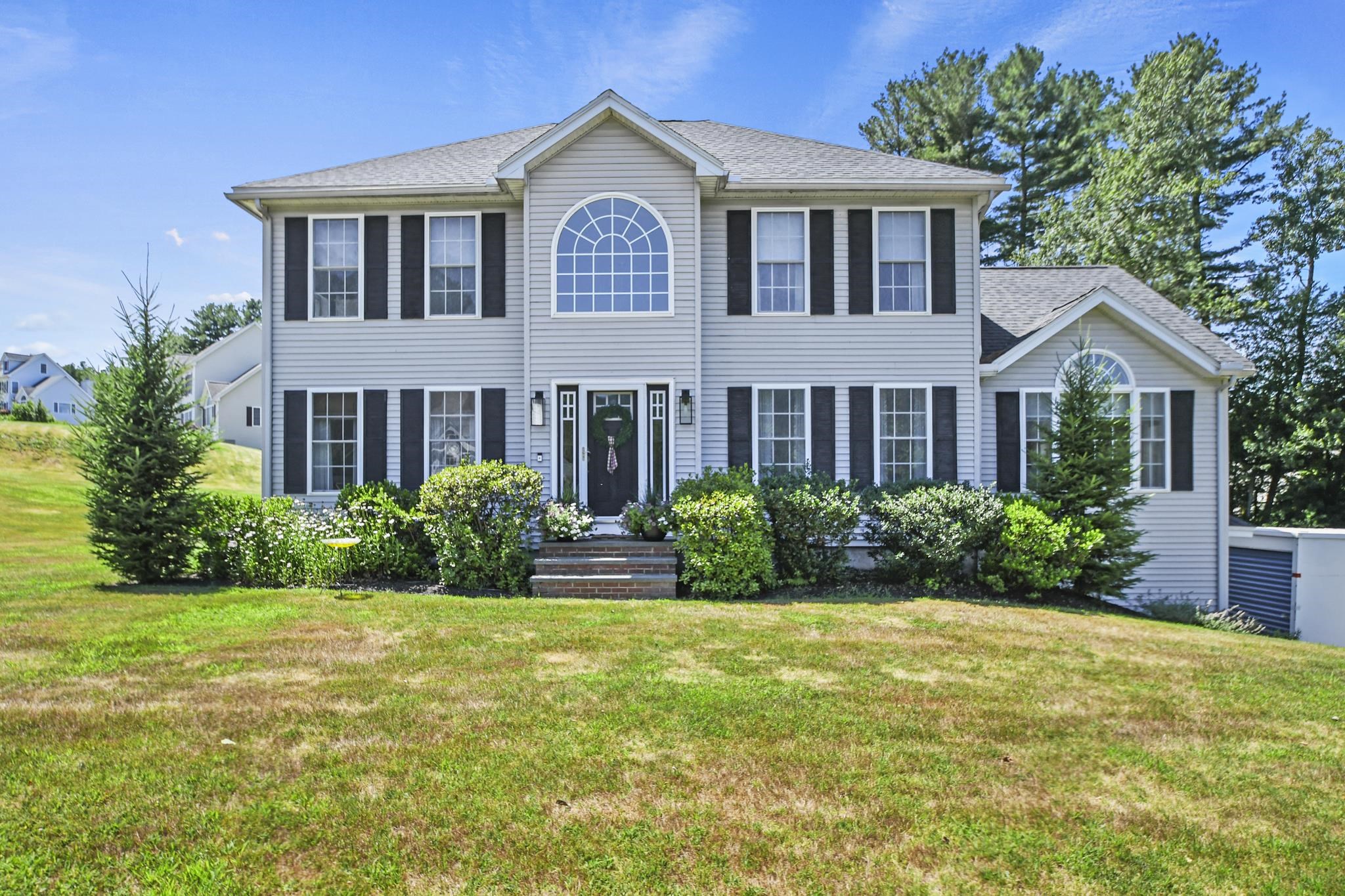 Welcome to 14 Deer Hill Circle - a 3-bedroom, 2.5-bath Colonial perfectly situated on an expansive 1.3 acres in a highly sought-after neighborhood. The grand tiled entry foyer sets the tone with raised panel wainscoting and a dramatic vaulted ceiling with chandelier. Gleaming hardwood floors, elegant crown molding, and recessed lighting extend throughout the main level, which features a formal dining room, a welcoming living room, and a stunning fireplaced family room with a cathedral ceiling, skylight, Palladian window, and built-in surround sound. The chef’s kitchen boasts quartz countertops, white cabinetry, a breakfast island, stainless appliances, and a gas range, opening to a composite deck. A stylish half bath with laundry completes this level. Upstairs, the primary suite offers a walk-in closet and spa-like en-suite. Two generously sized bedrooms and a beautifully appointed full bath complete the second floor, offering comfort and versatility for family, guests, or home office use. The lower level features a custom ship-lap mudroom entry from the 2-car garage and a finished bonus room. Outside, enjoy landscaped grounds, patio, storage shed, above-ground pool & fire pit with lights. Discover the perfect blend of craftsmanship and comfort—schedule your visit today! Seller to provide a $7,500 credit for the 3 upstairs carpets to enable buyer to choose new flooring.